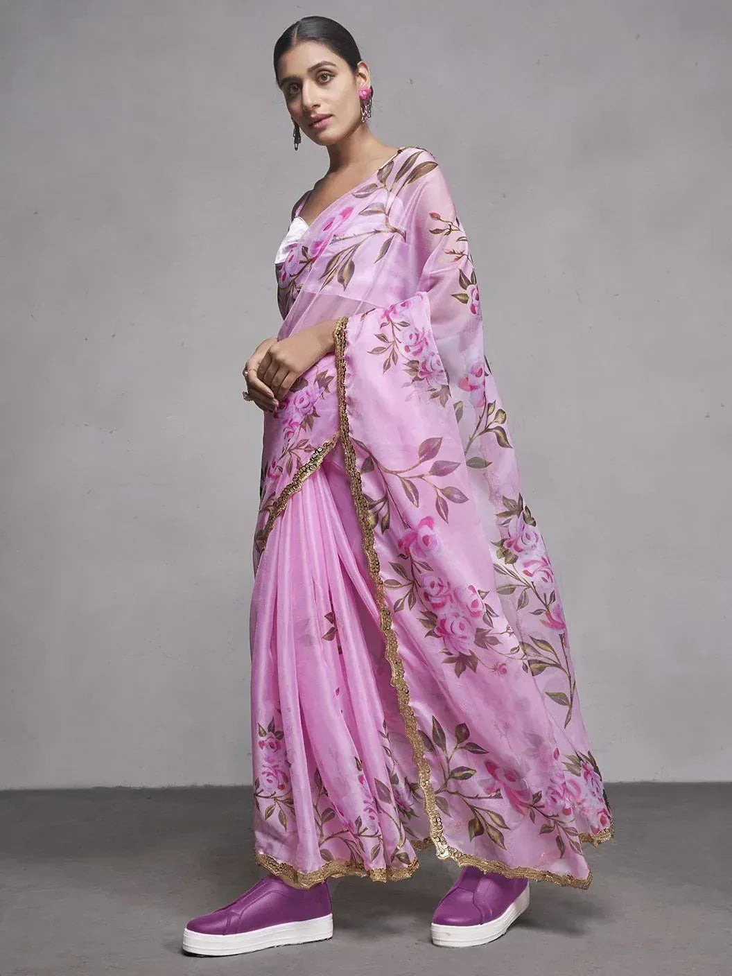 Pink floral printed saree with gold trim, styled with purple platform shoes for modern ethnic look