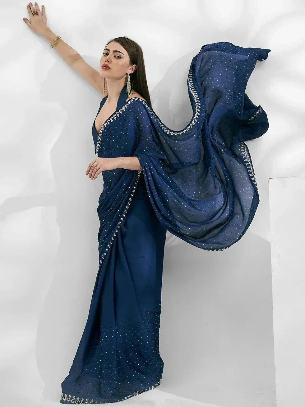 Elegant navy blue saree with delicate white embroidery and flowing drape, perfect for Indian ethnic occasions