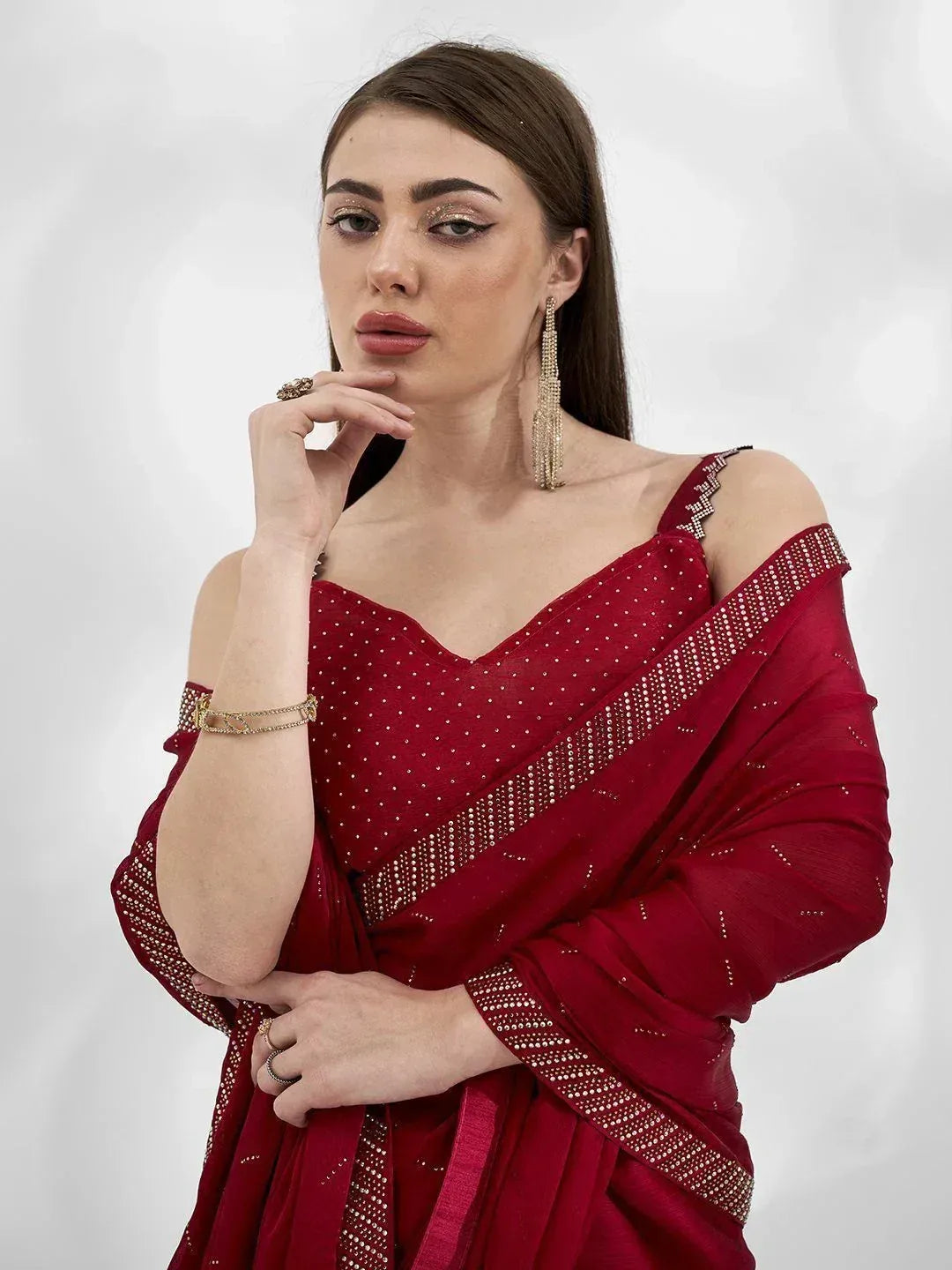 Elegant maroon saree with off-shoulder blouse and sparkling embellishments, perfect for Indian ethnic occasions.