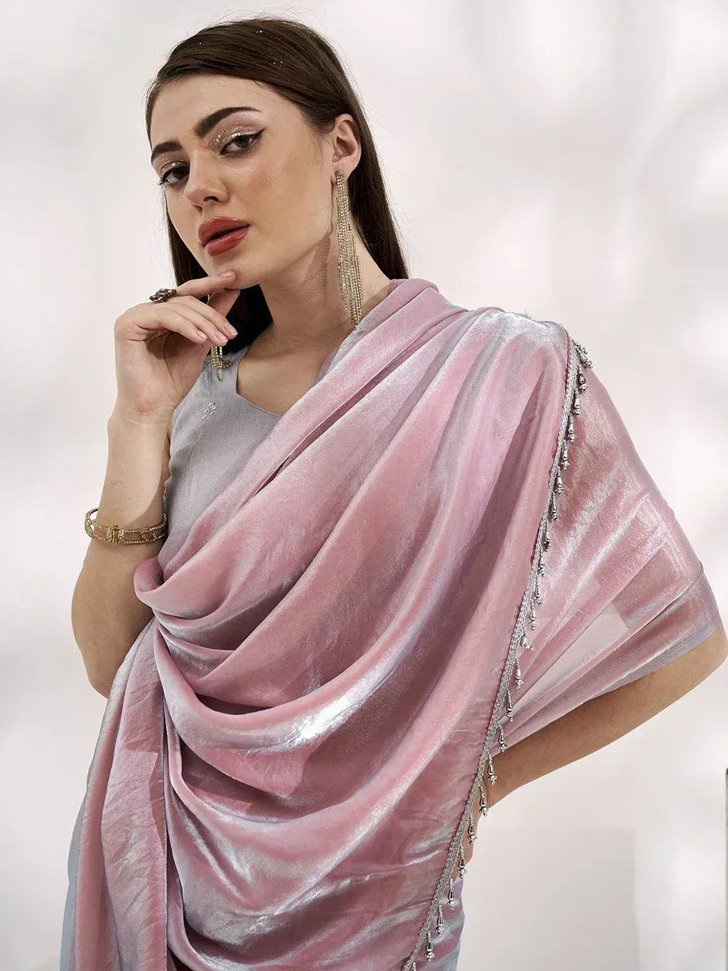 Elegant pink velvet saree with silver embellishments, styled with traditional Indian jewelry