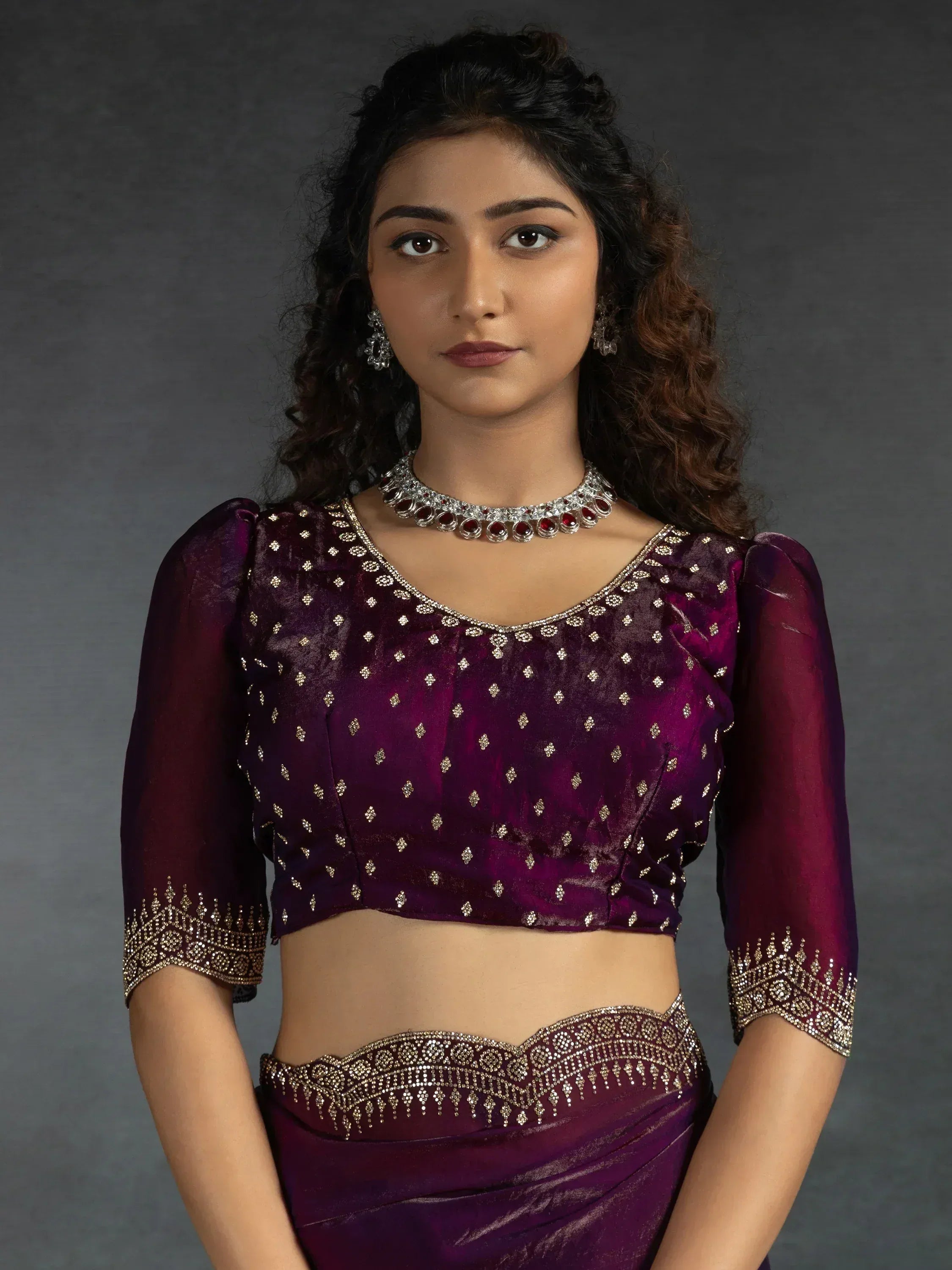 Elegant purple ethnic blouse with gold embroidery and matching skirt, perfect for Indian celebrations.