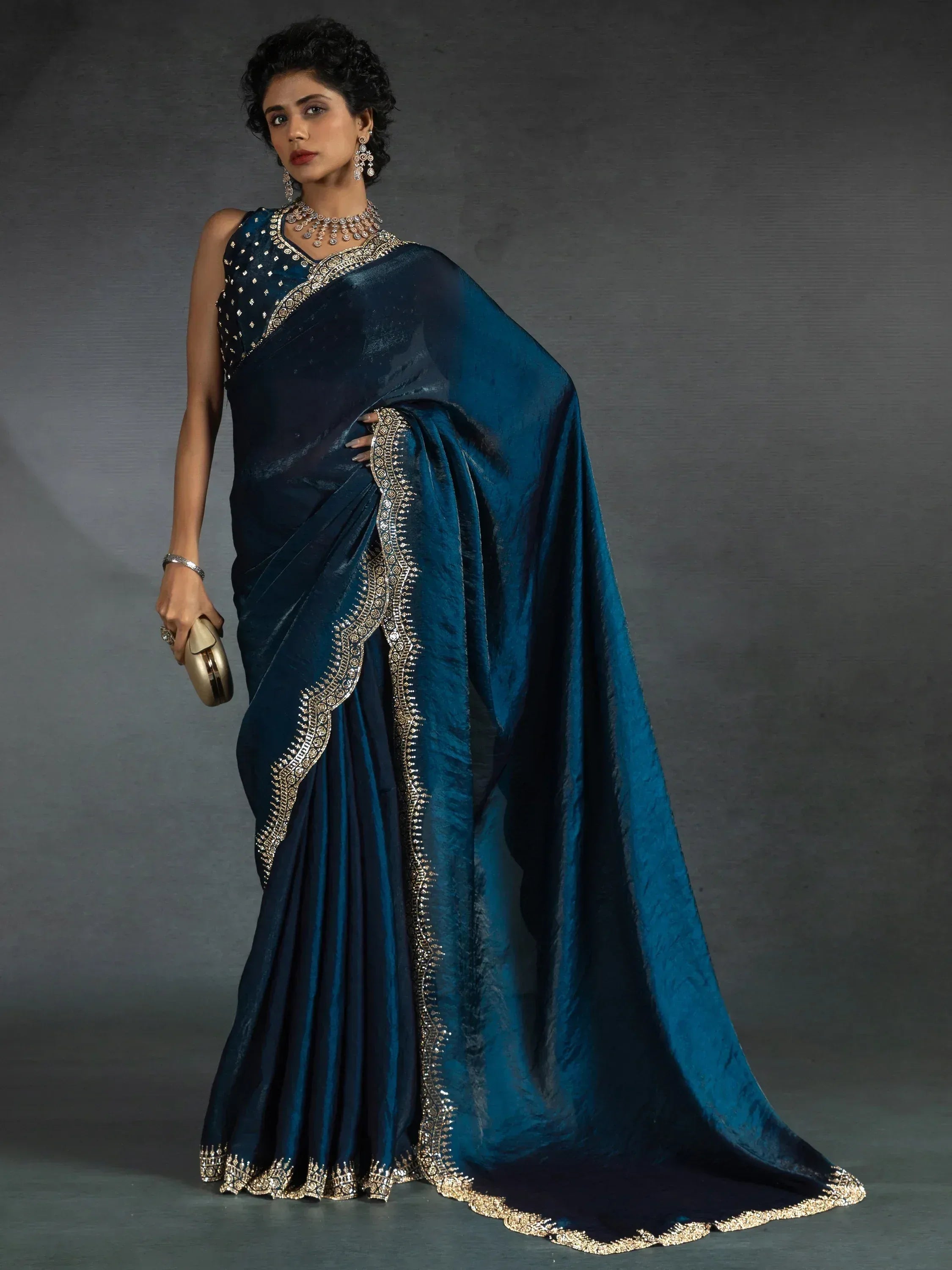 Elegant teal saree with gold embroidery, perfect for Indian ethnic wear occasions.