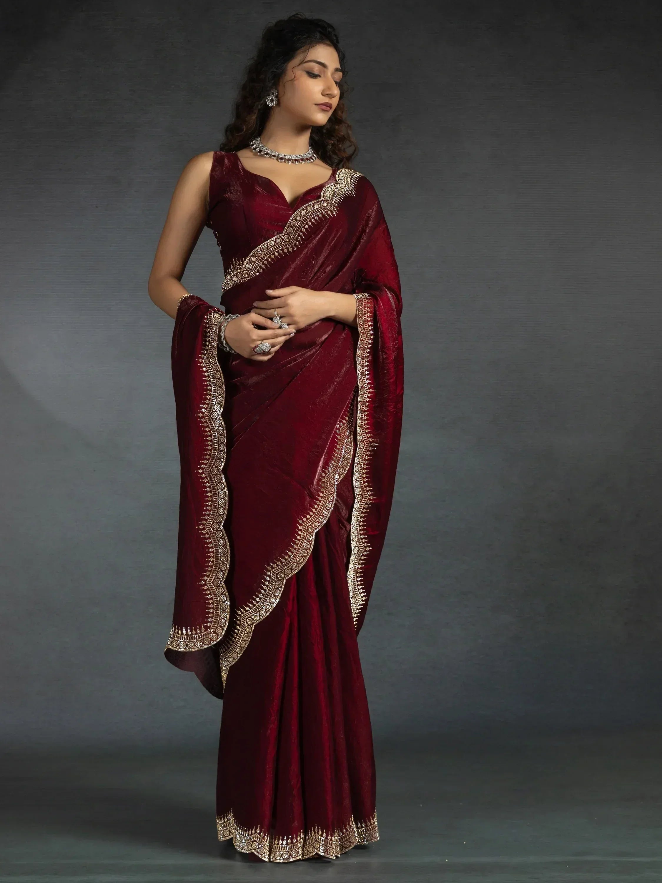 Elegant maroon velvet saree with gold embroidery, perfect for Indian ethnic wear occasions.