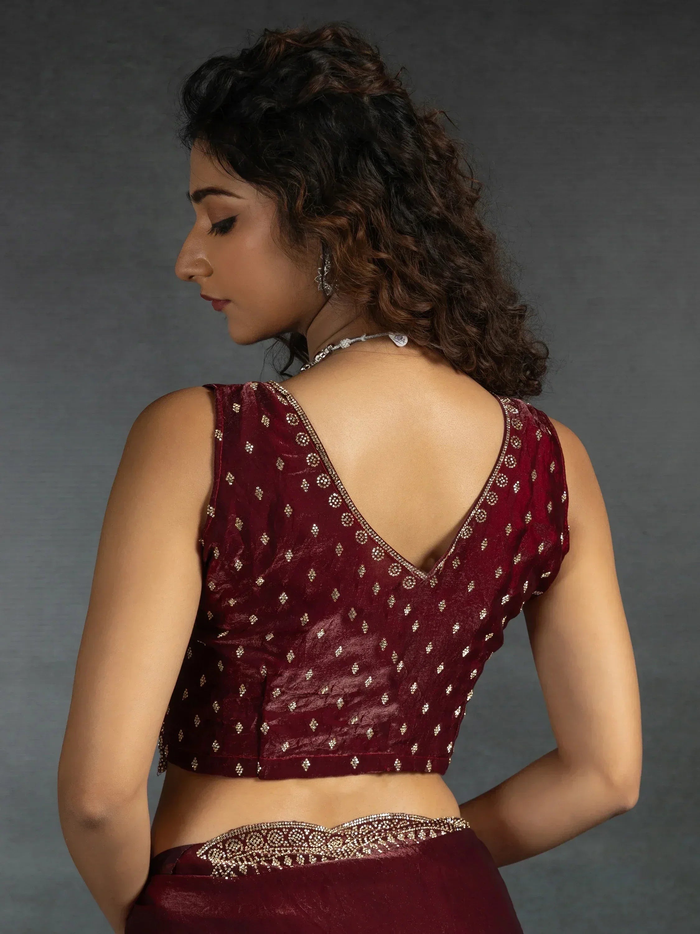 Maroon ethnic blouse with gold embroidery and backless design