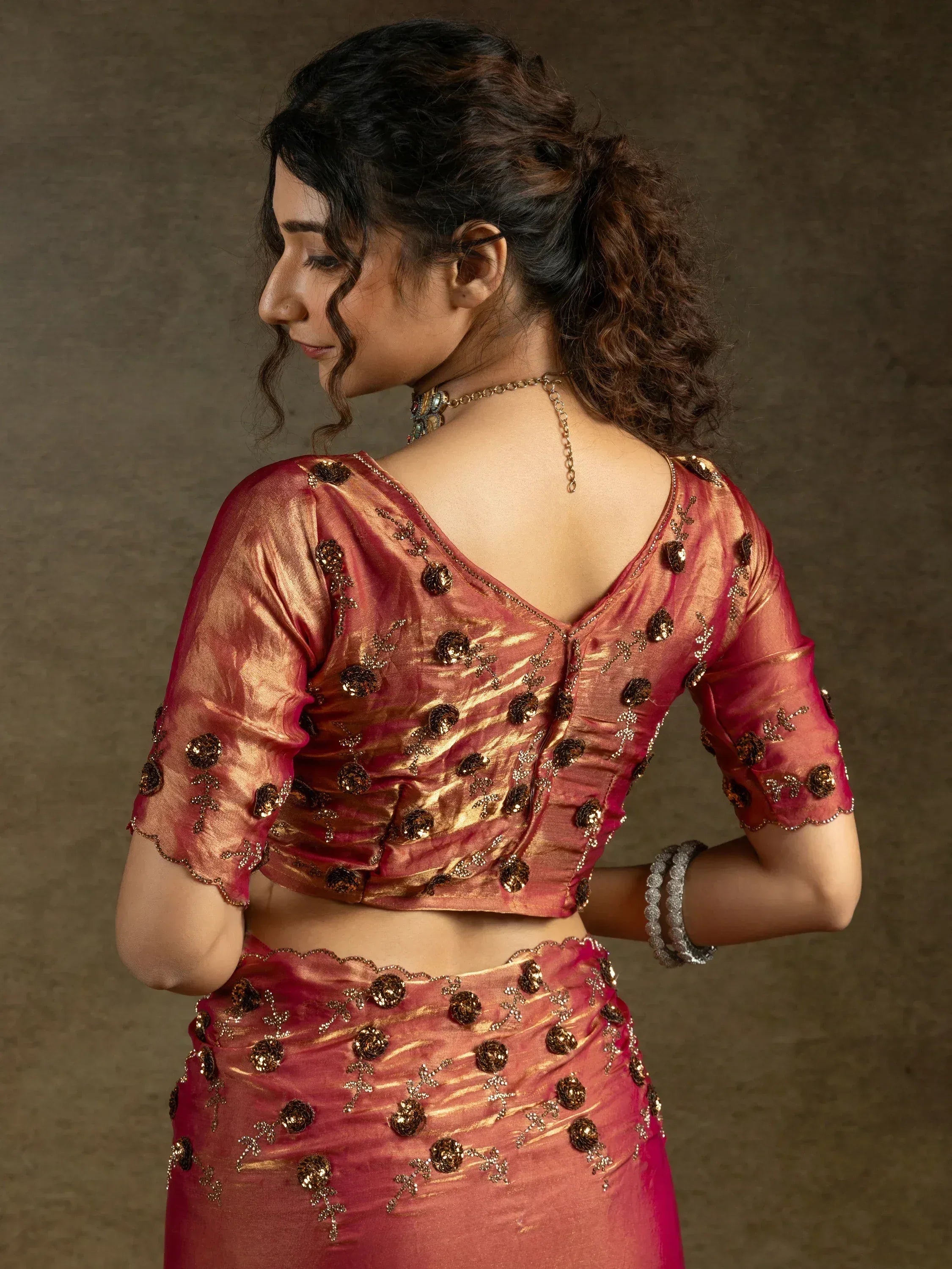 Elegant pink ethnic lehenga choli with gold floral embroidery and sheer sleeves