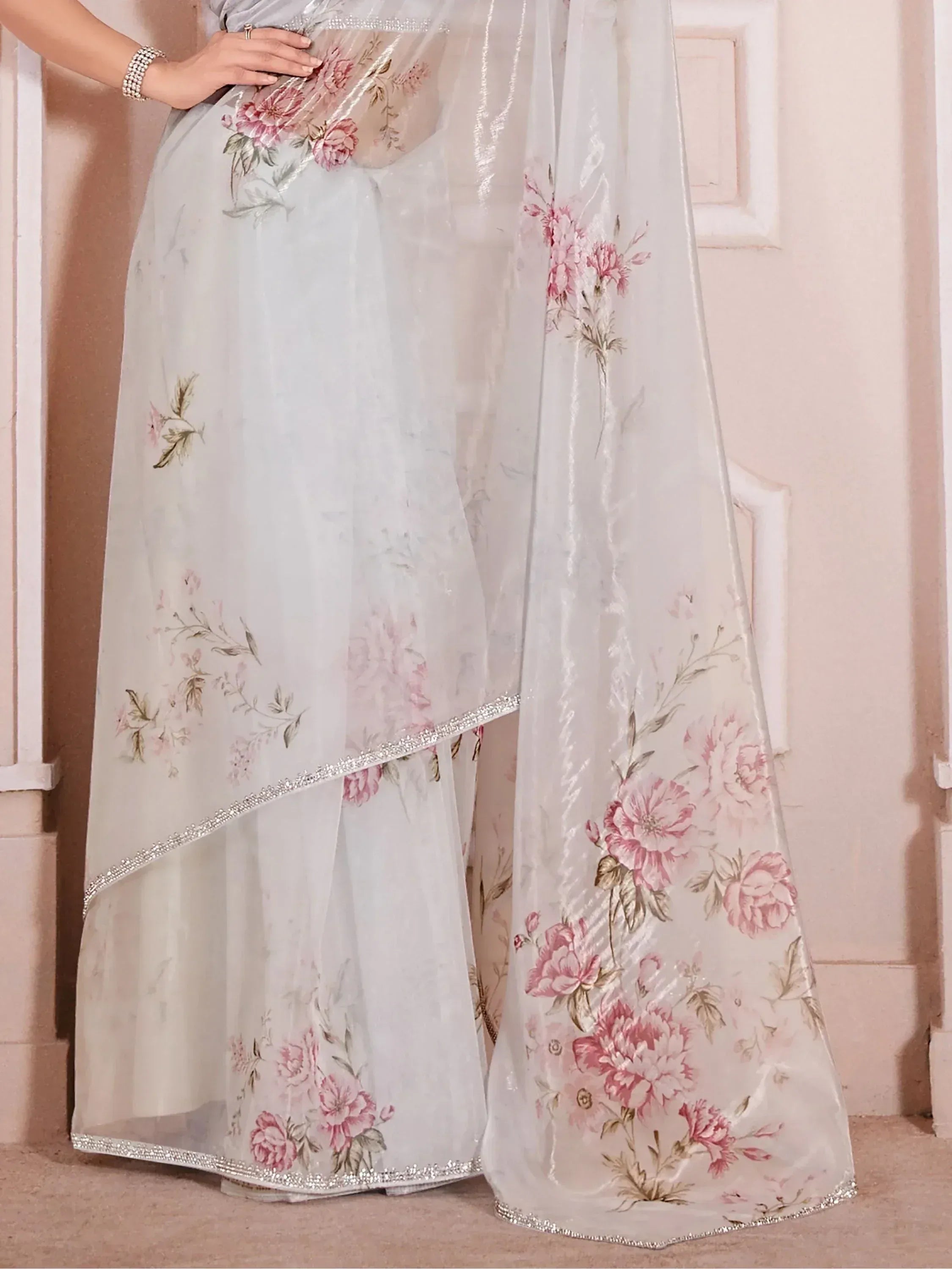 Elegant white saree with pink floral print and silver border, perfect for ethnic occasions