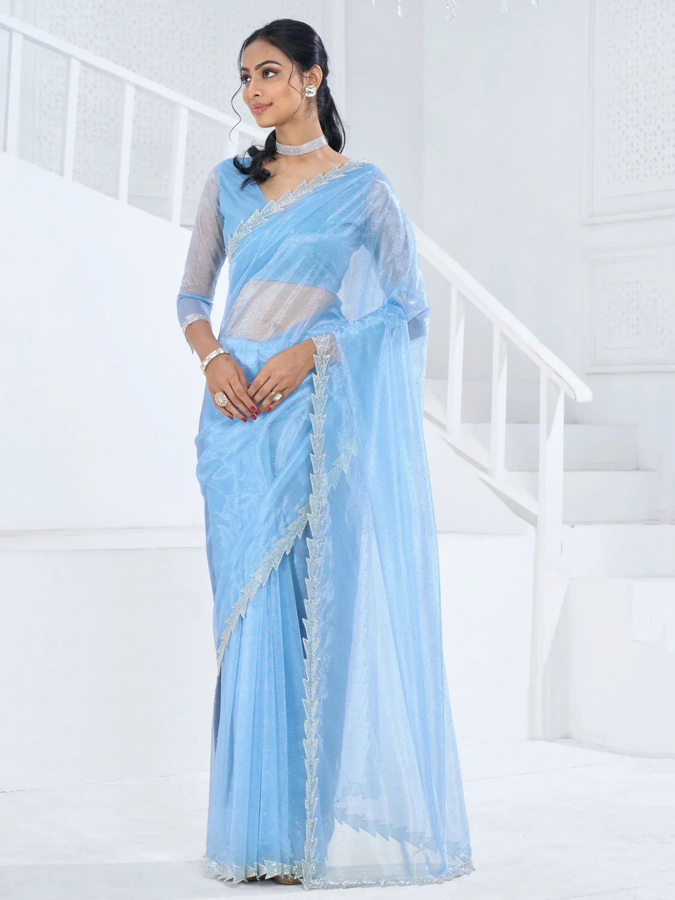 Light blue designer saree with silver embellishments, perfect for Indian ethnic wear occasions
