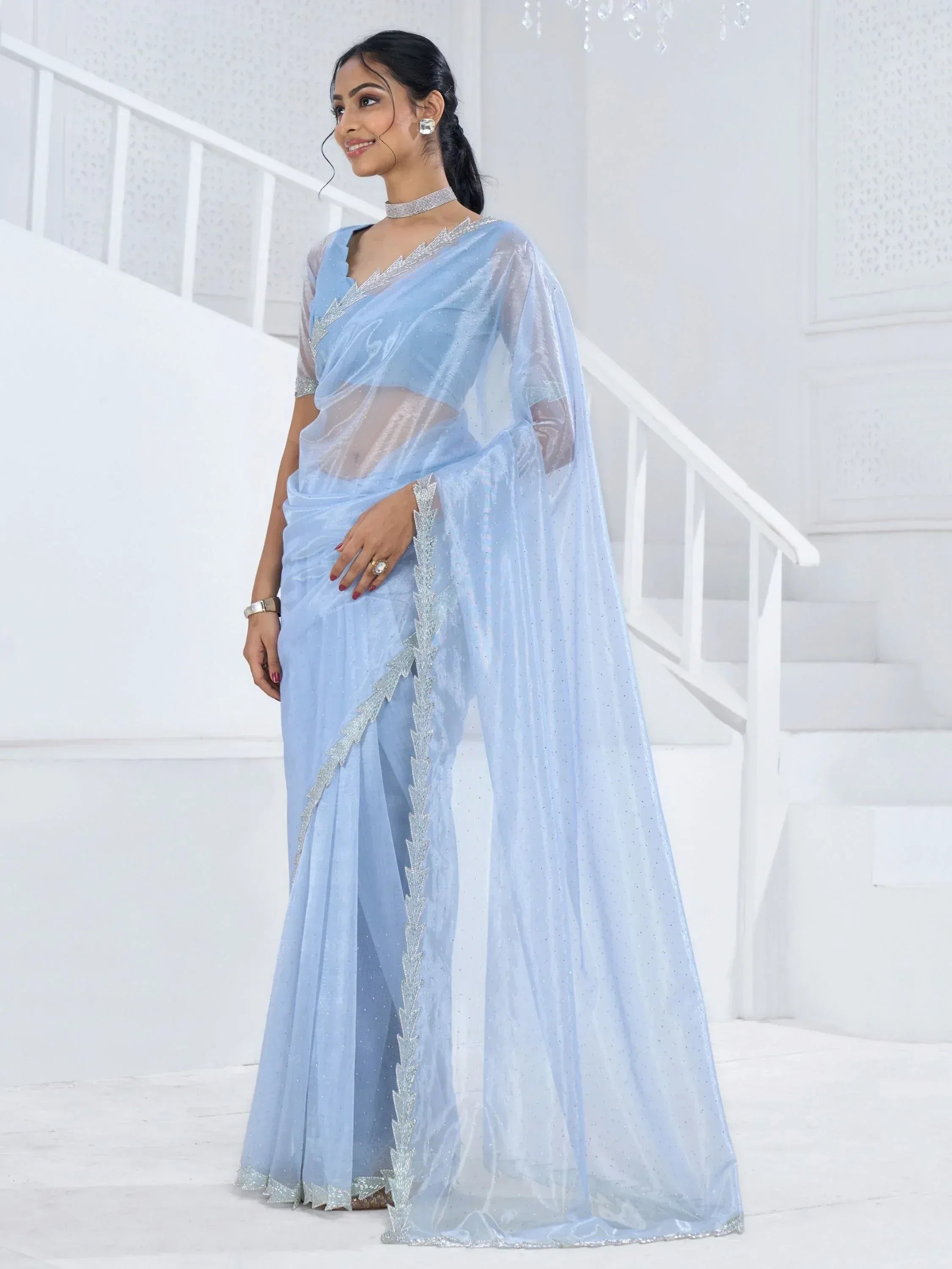 Light blue designer saree with silver embroidery, sheer blouse, and elegant drape for Indian ethnic wear