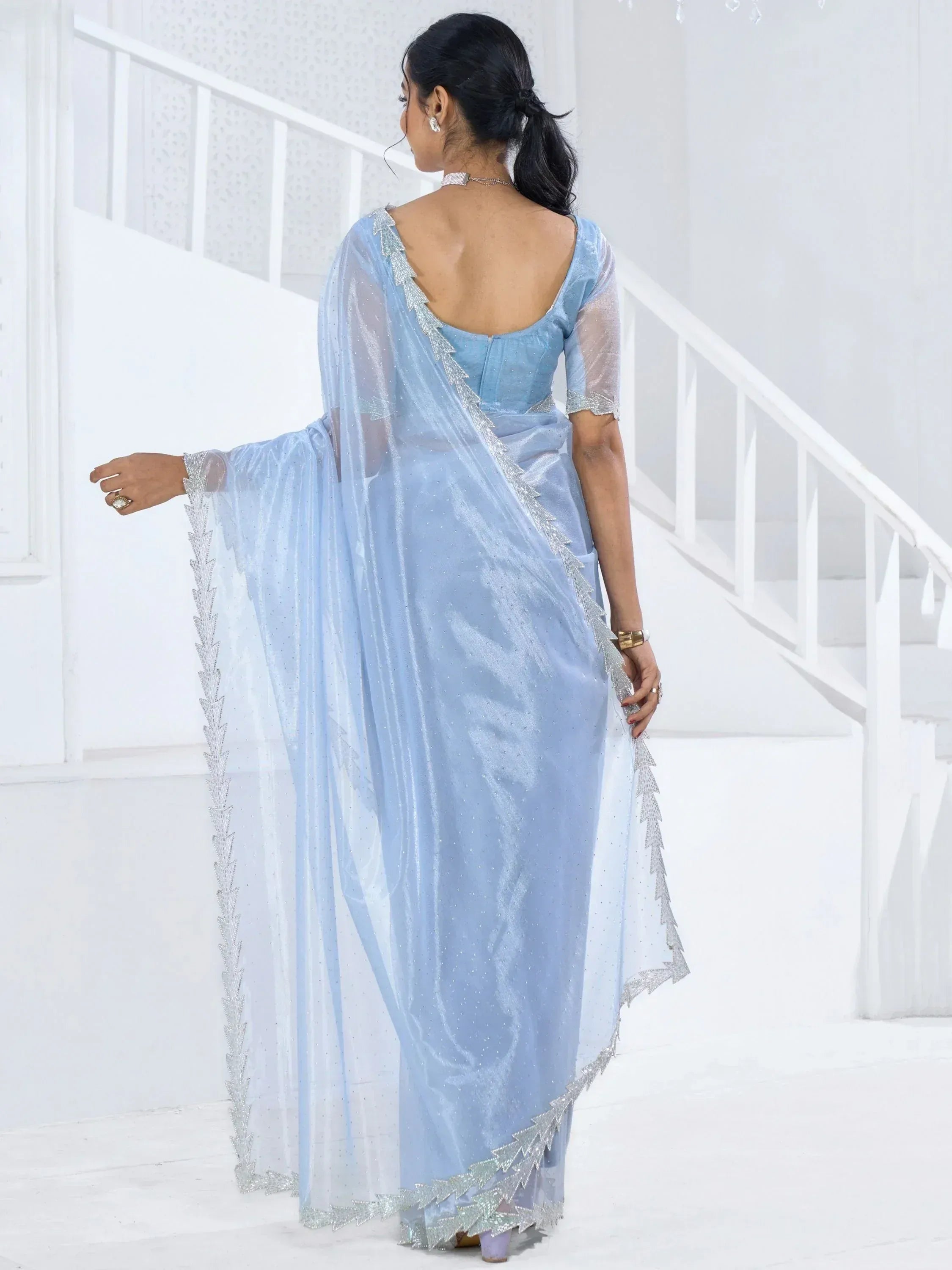 Light blue designer saree with silver embellishments and sheer cape, elegant ethnic wear for women