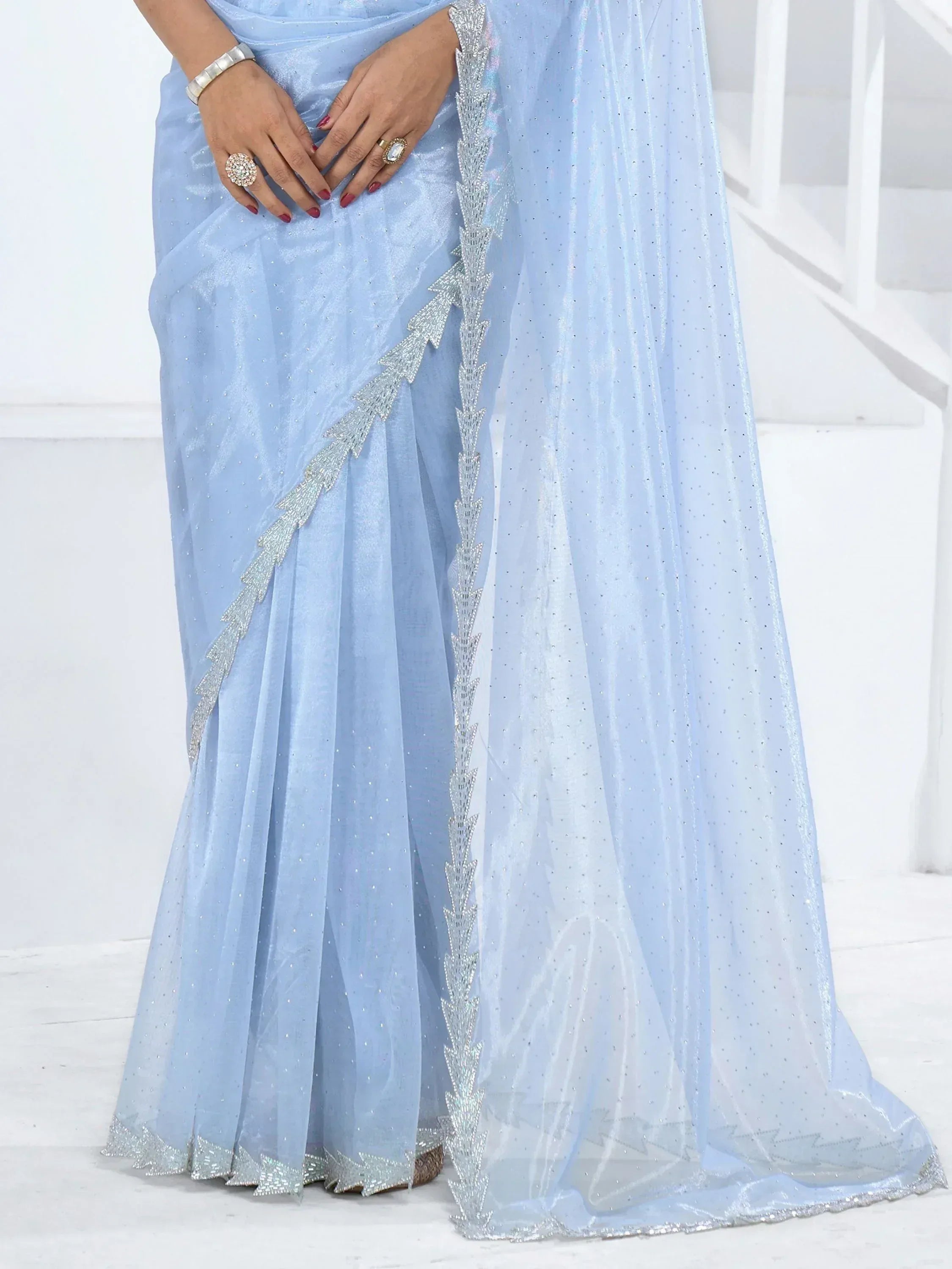 Light blue saree with silver sequin border and embellished pallu, ideal for Indian ethnic occasions