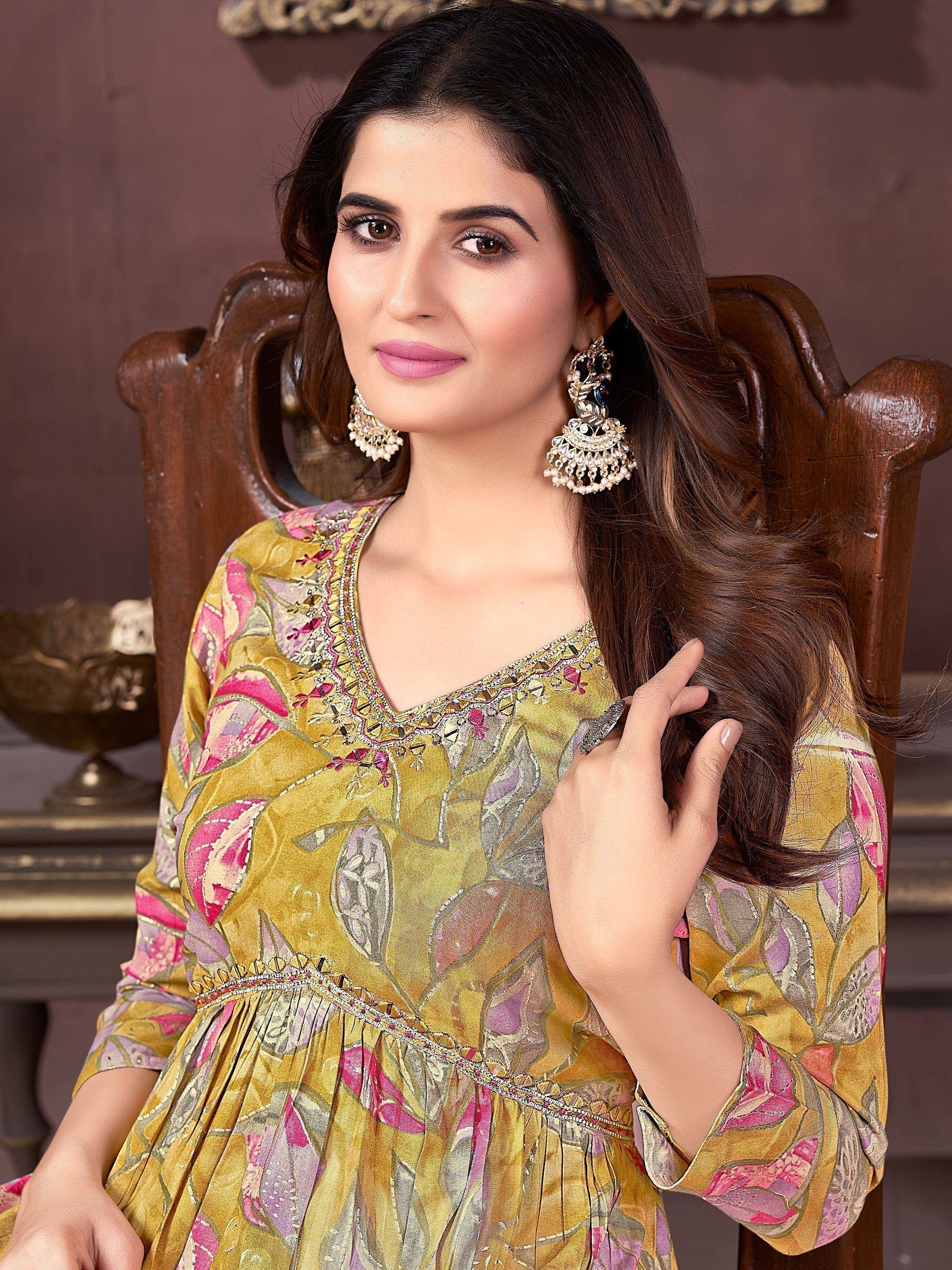 Woman in floral print ethnic gown with embroidery, styled with jhumka earrings for festive occasions
