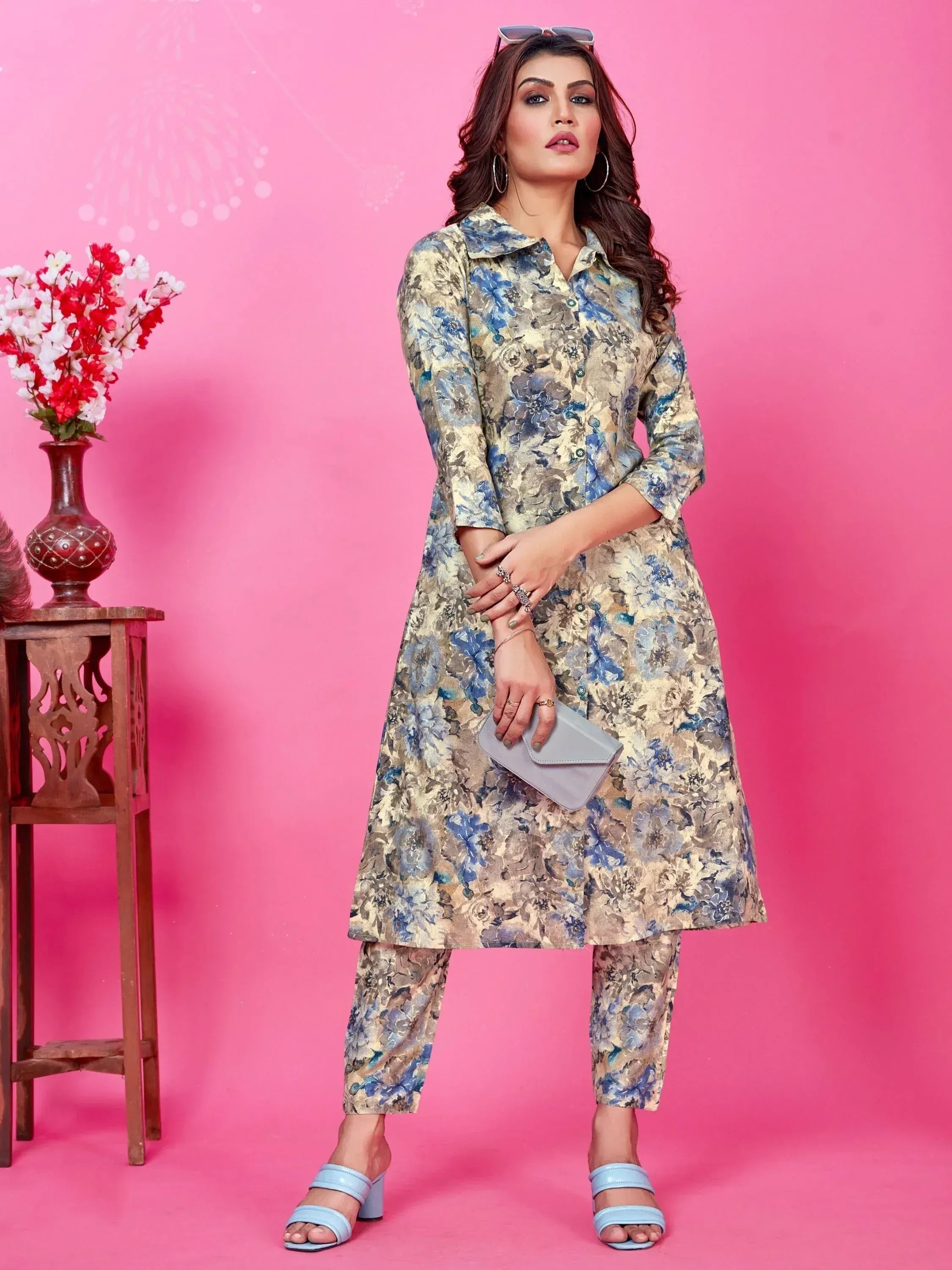 Floral printed ethnic kurta set with matching pants, styled with blue heels and clutch