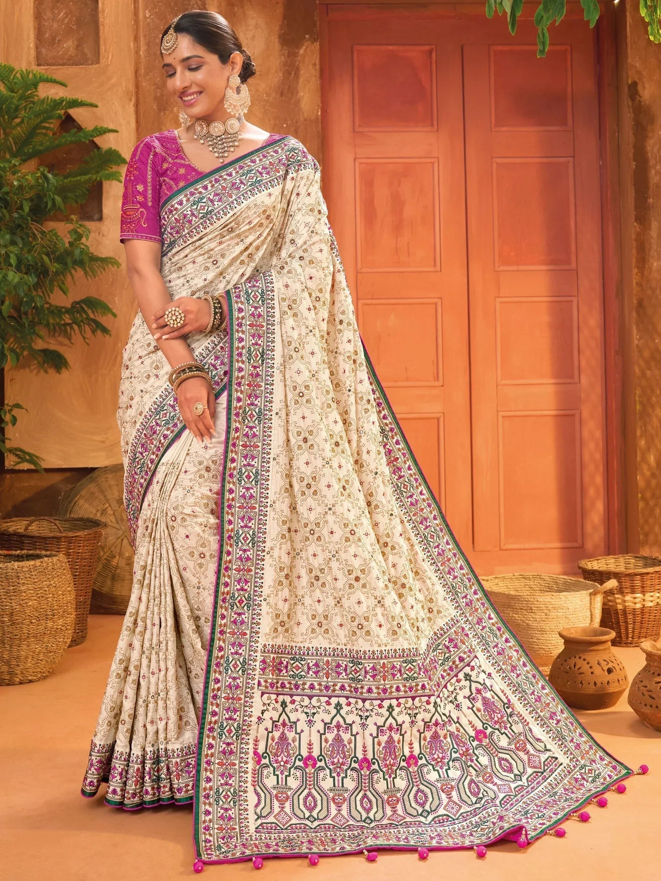 Elegant ivory saree with pink and green embroidery, paired with matching blouse, perfect for Indian ethnic wear