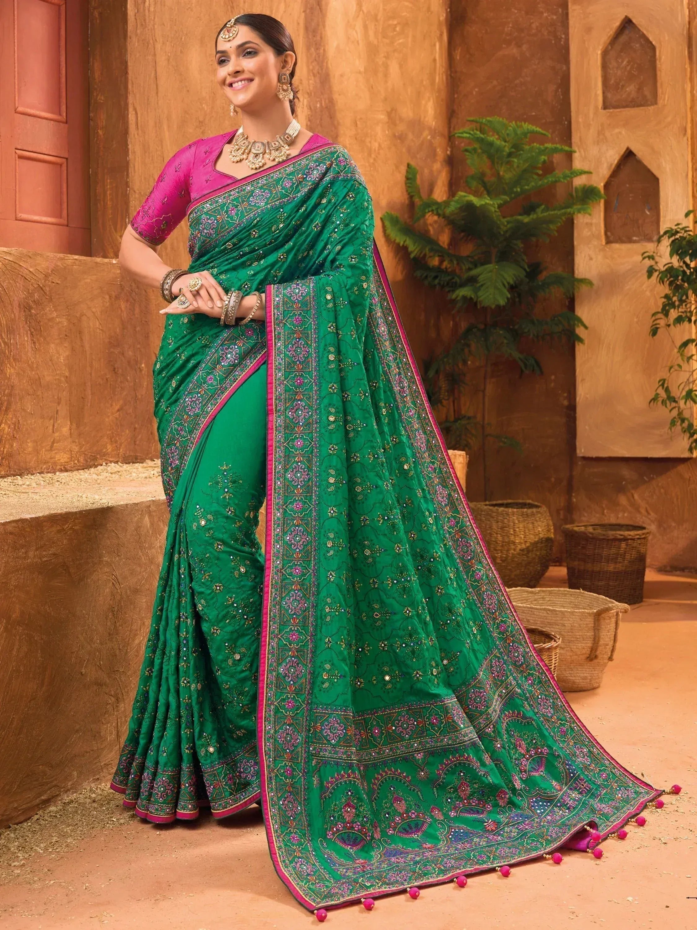 Emerald green embroidered saree with pink border, perfect for Indian ethnic wear occasions