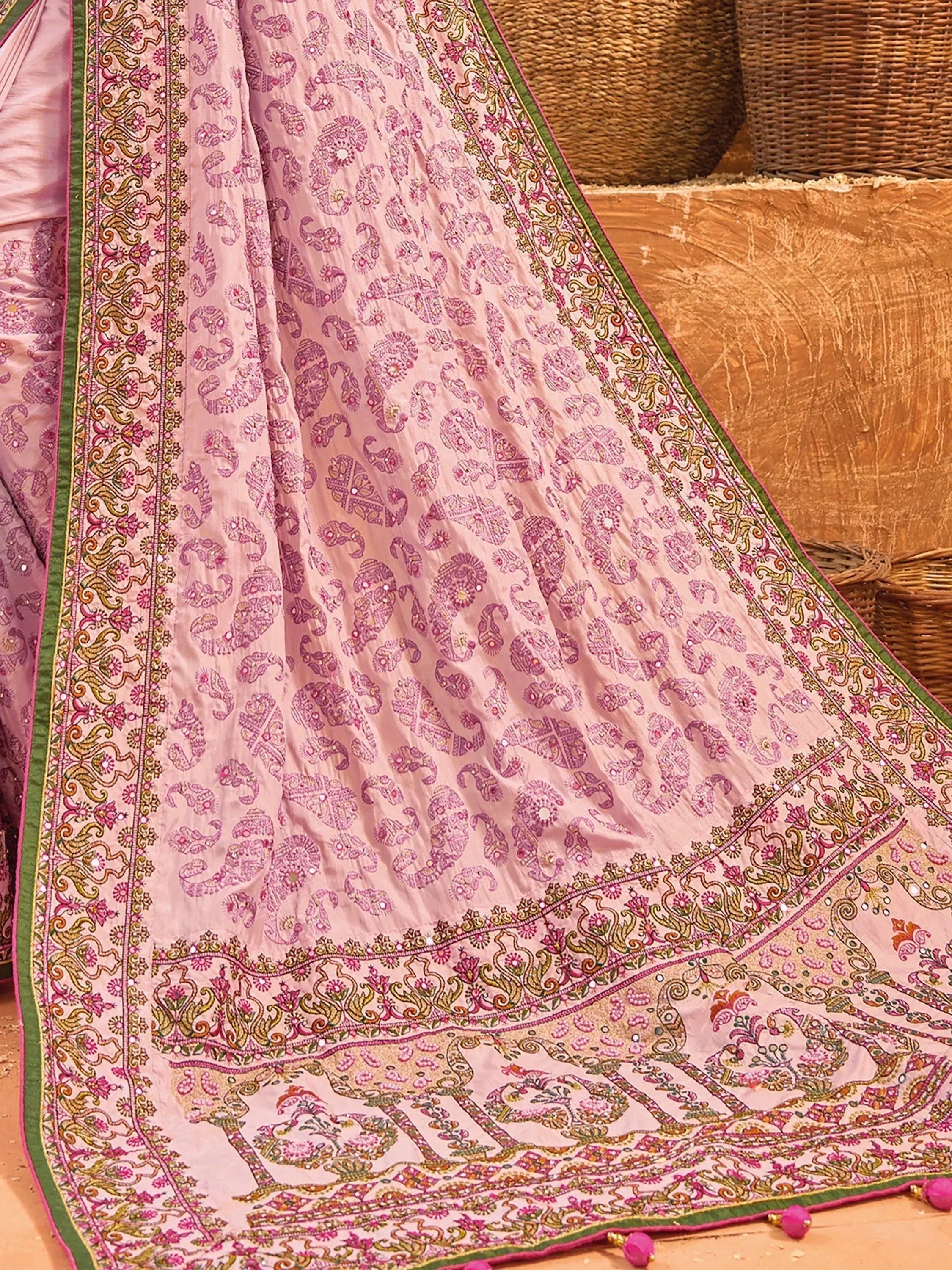 Pink ethnic saree with intricate paisley print, floral border, and mirror work, perfect for Indian occasions.