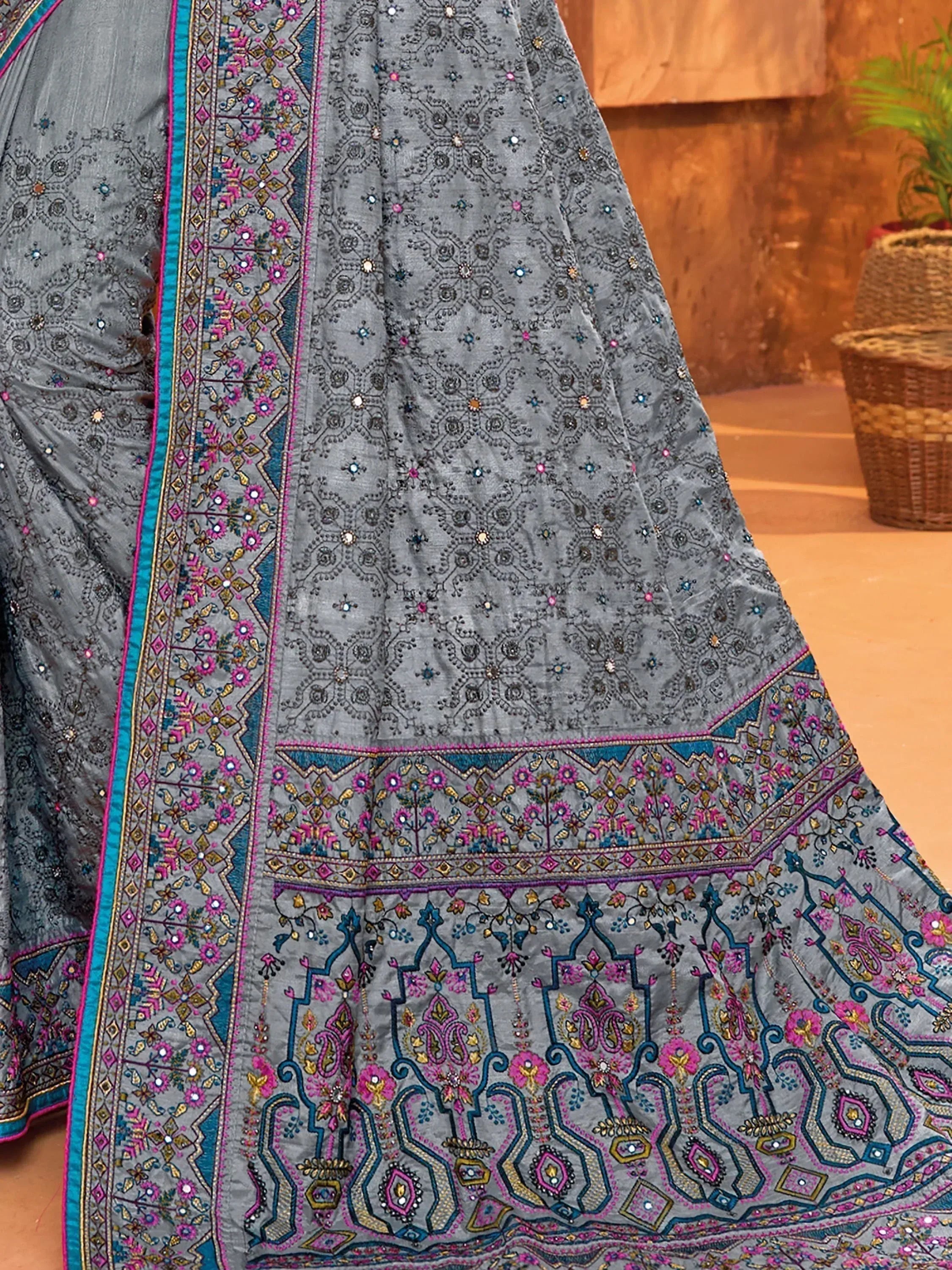 Grey embroidered lehenga with pink and blue floral border, perfect for Indian ethnic wear