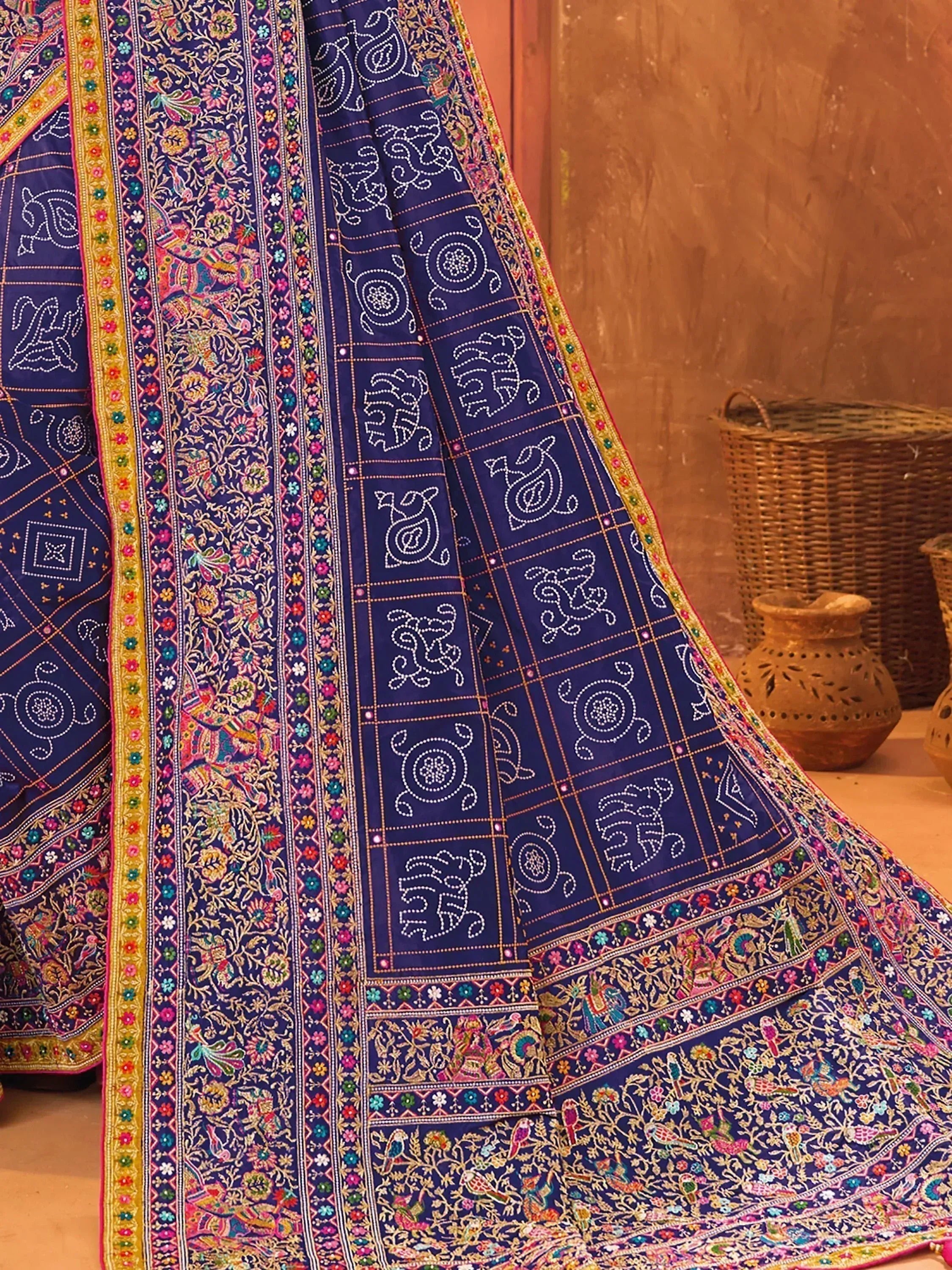 Blue embroidered Indian ethnic saree with floral and elephant motifs, traditional craftsmanship