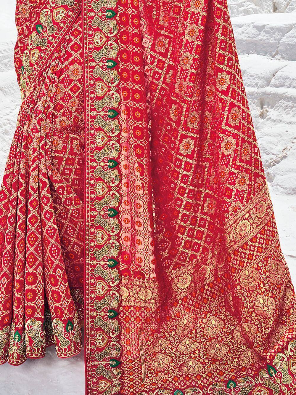 Red ethnic saree with gold elephant and floral motifs, perfect for Indian weddings and festive occasions.