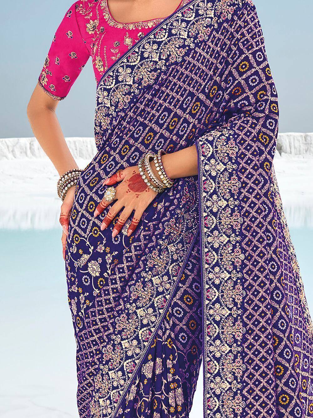 Purple printed saree with pink blouse, floral embroidery, and traditional Indian ethnic wear design