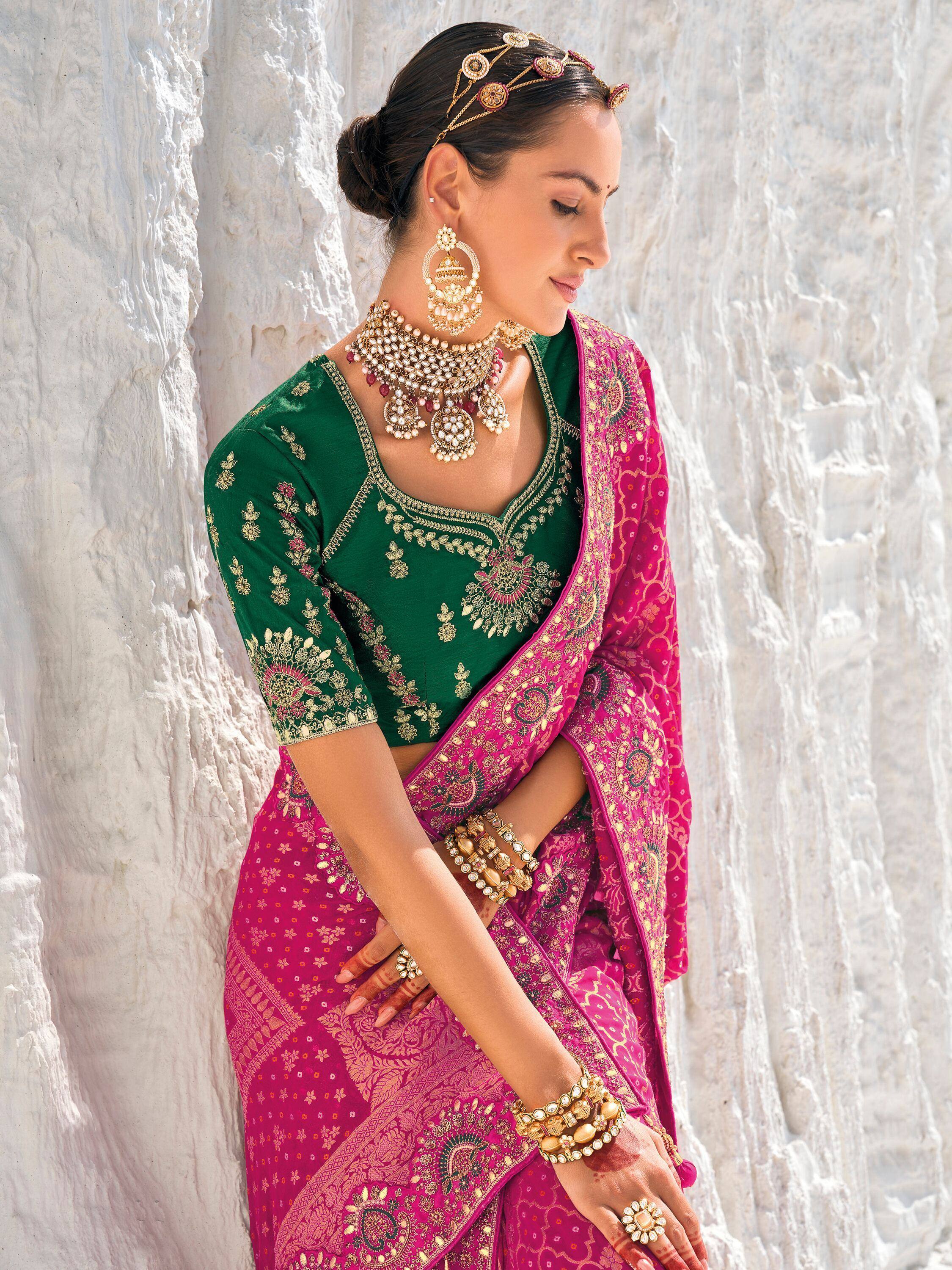 Woman in green embroidered blouse with pink saree, traditional Indian ethnic wear, gold jewelry
