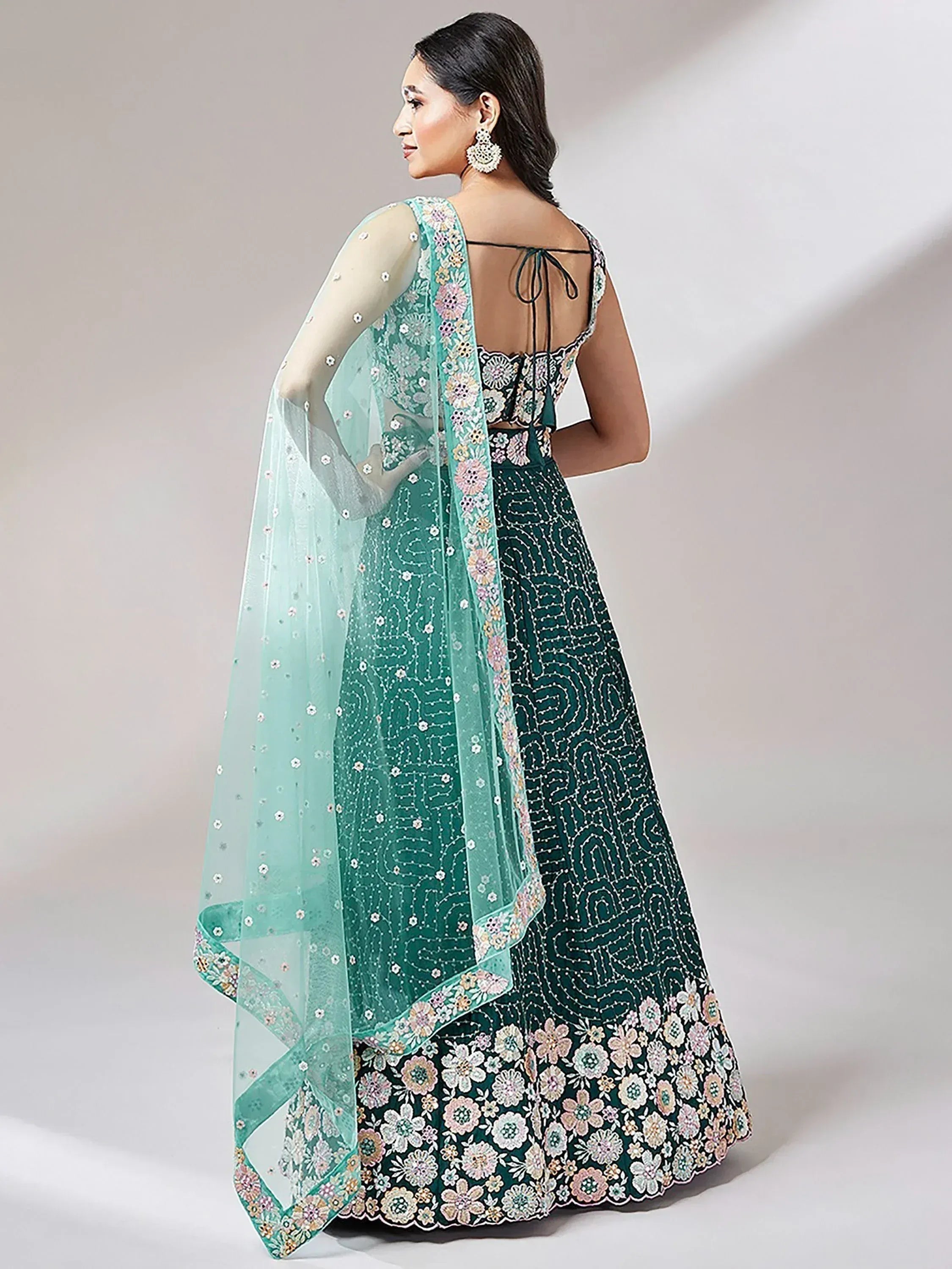 Emerald green floral embroidered lehenga choli with sheer dupatta, back view