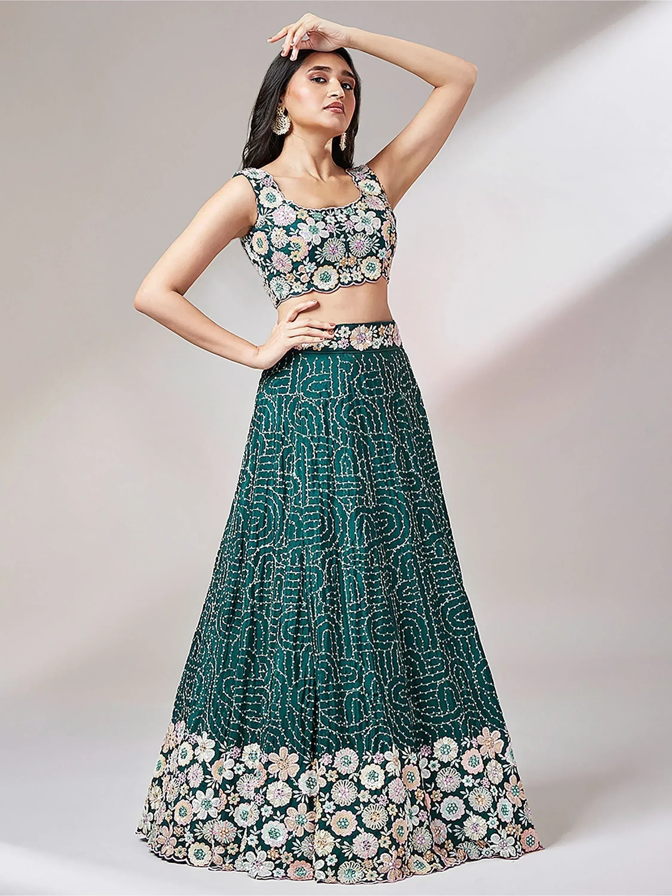 Emerald green floral embroidered lehenga choli with scalloped crop top and patterned skirt, perfect for Indian ethnic occasions.