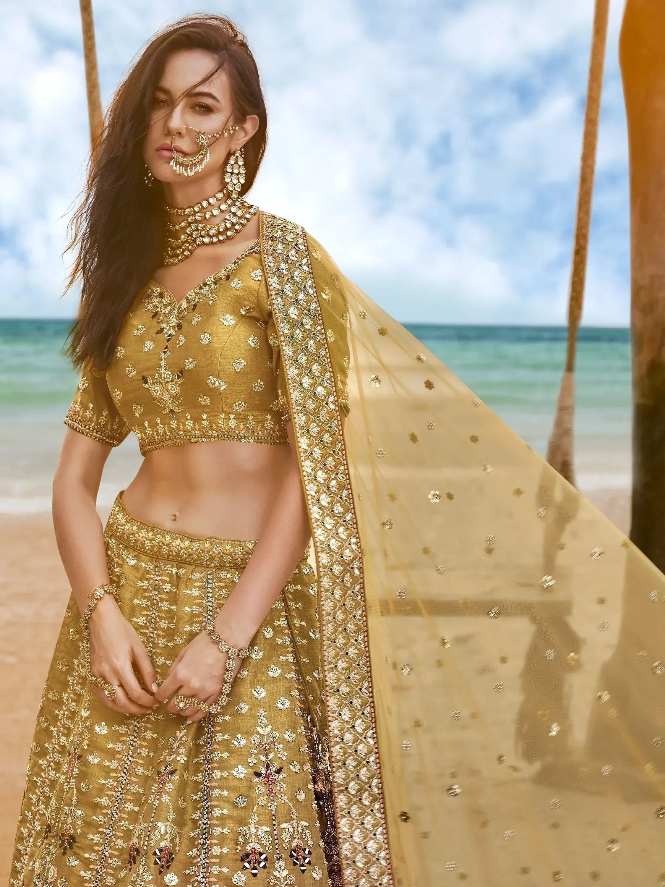 Golden embroidered lehenga choli with dupatta, perfect for Indian weddings and festive occasions.