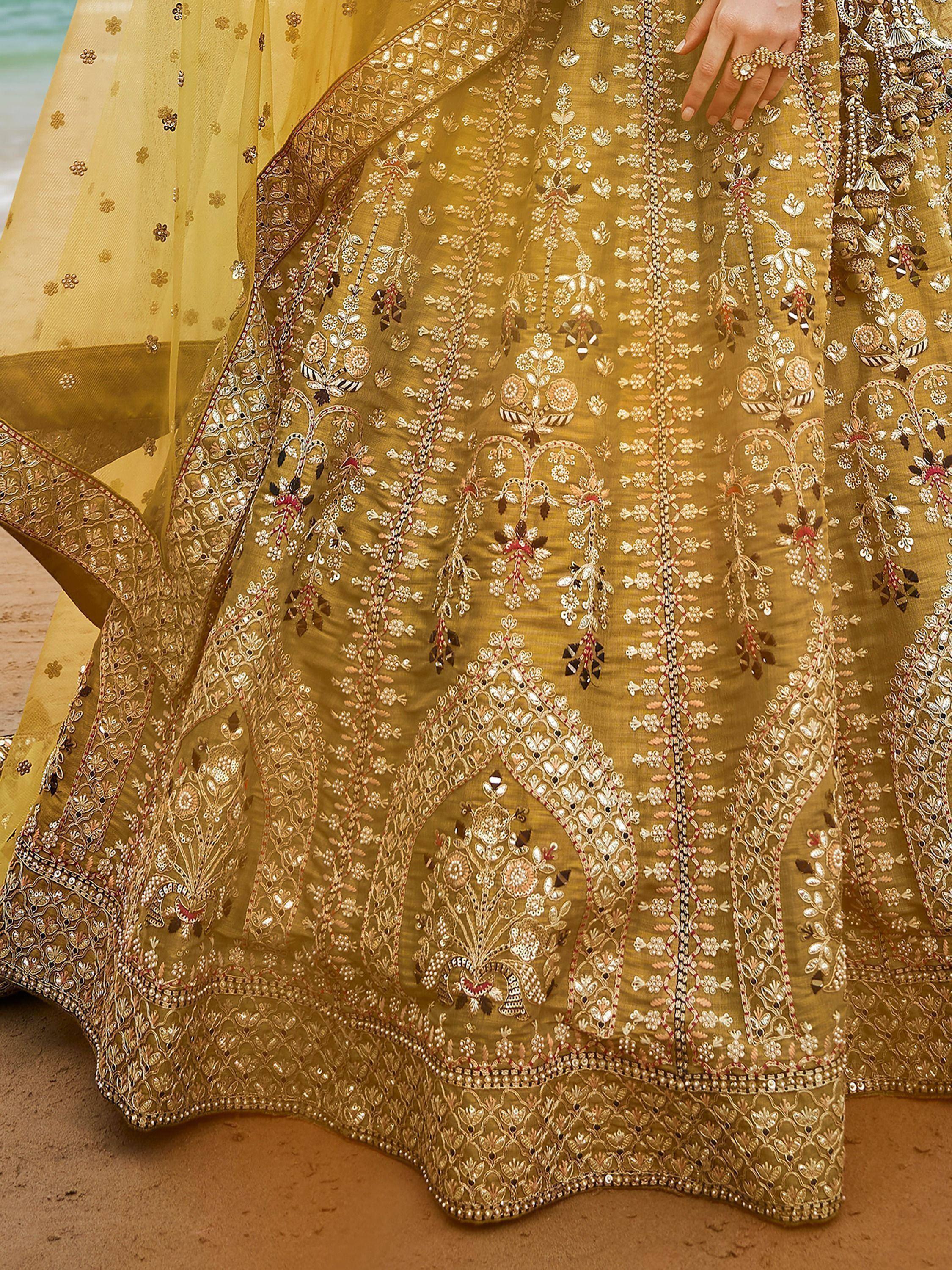 Golden embroidered lehenga choli with floral motifs, perfect for Indian ethnic wear occasions.