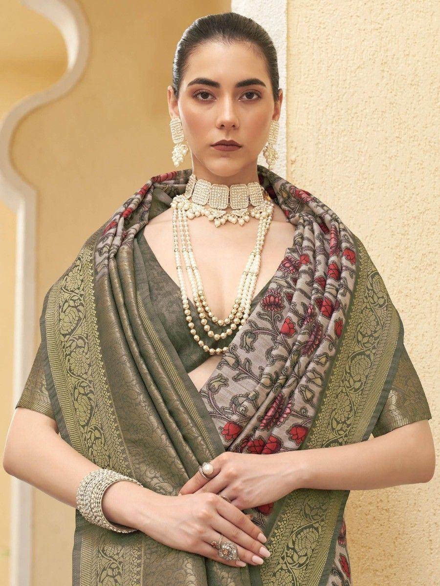 Elegant olive green saree with red floral print, paired with pearl jewelry and traditional ethnic wear.