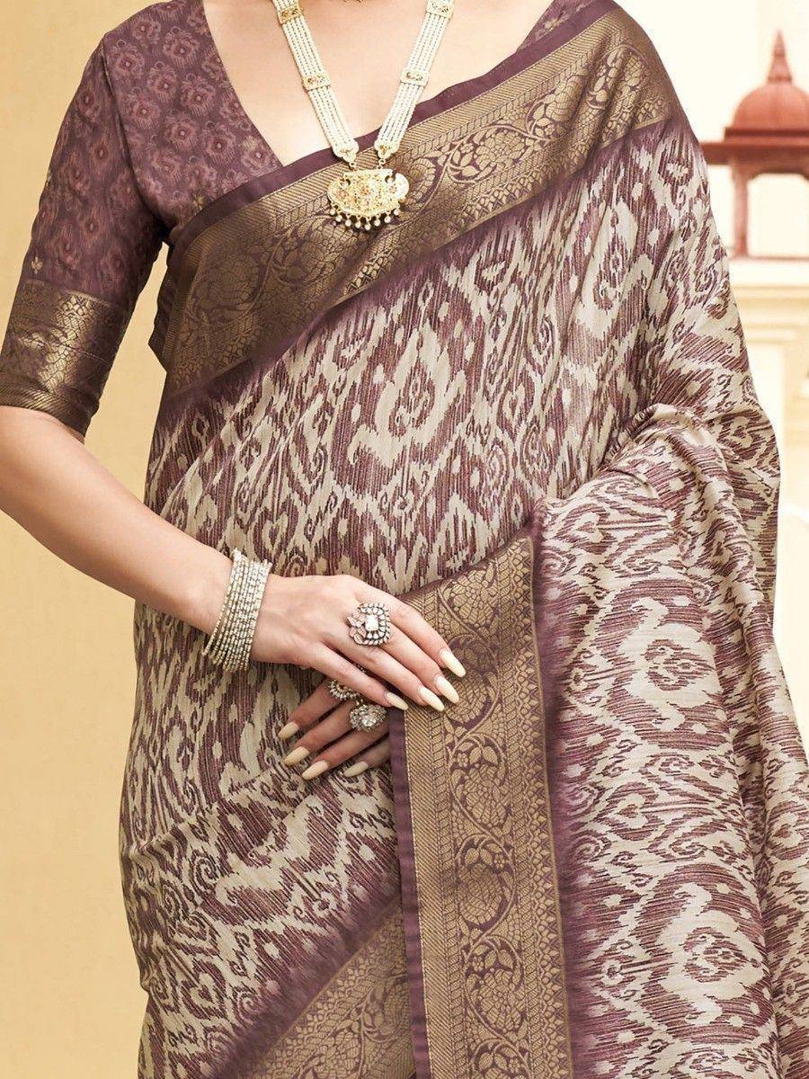 Elegant purple and gold ikat saree with intricate woven patterns, paired with traditional jewelry for ethnic wear.