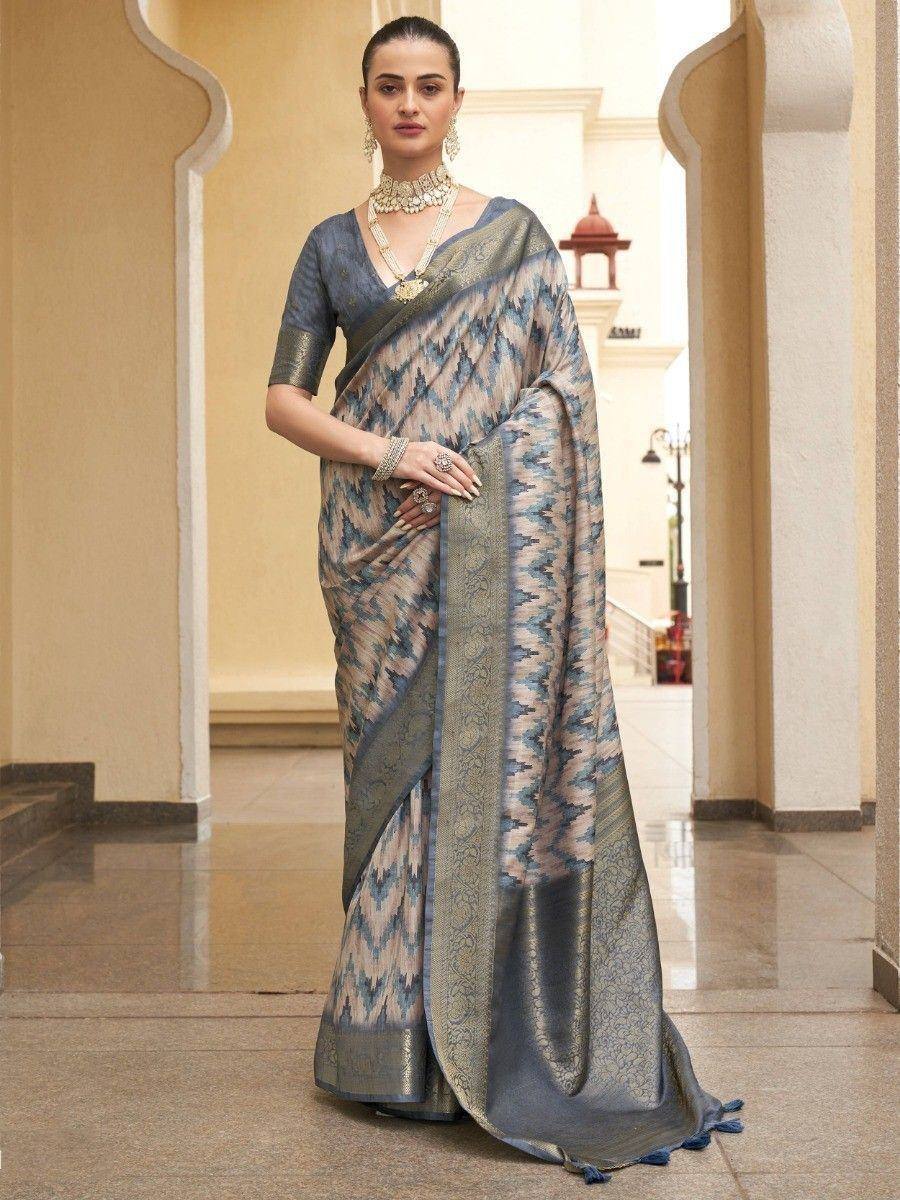Blue and beige ikat saree with gold border, styled with designer jewelry for ethnic occasions