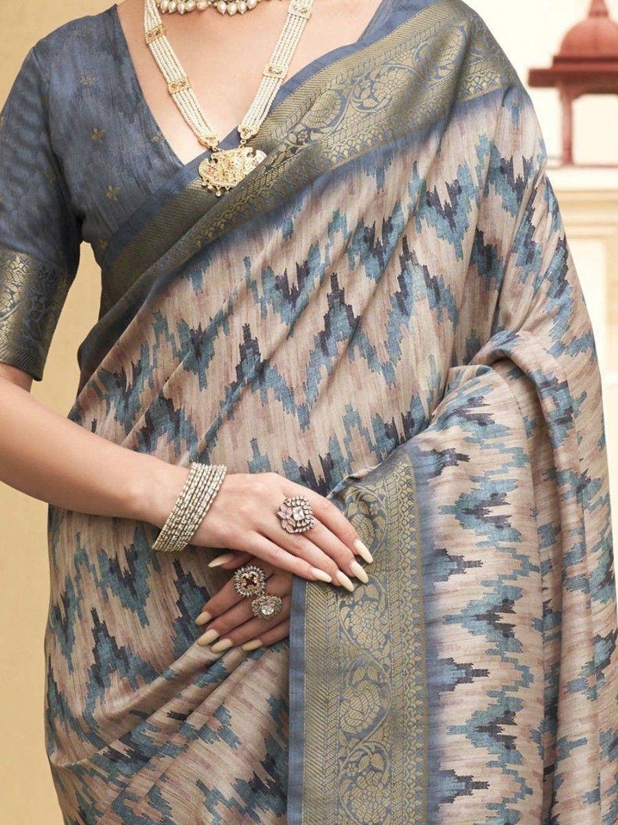 Blue and beige ikat saree with gold border, paired with designer jewelry for ethnic wear
