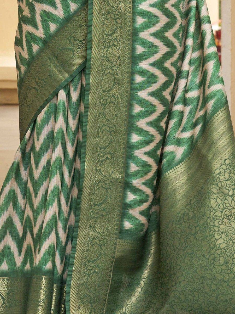 Green and white ikat patterned saree with intricate woven border, ethnic Indian wear