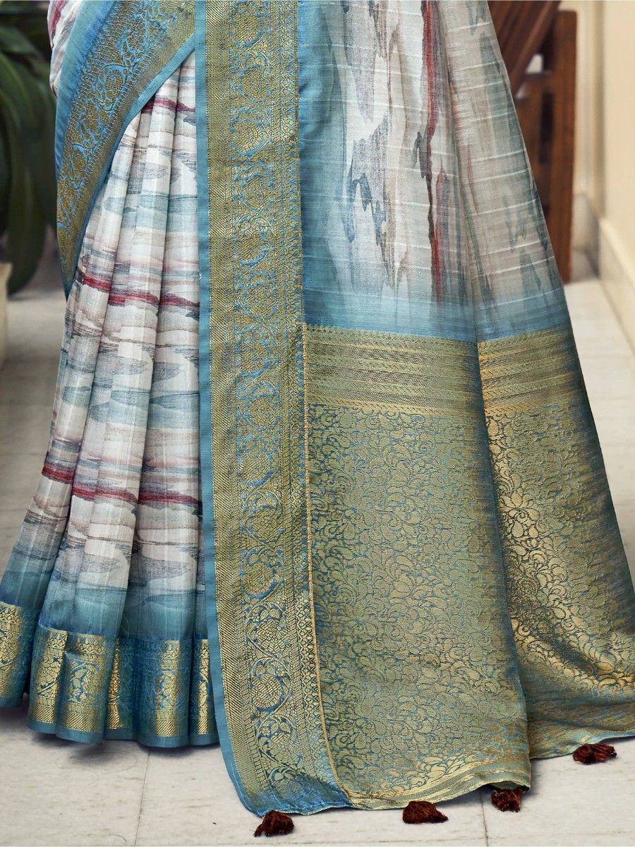 Blue and gold designer saree with intricate border and tassels, perfect for ethnic occasions