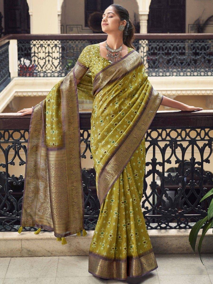 Elegant olive green saree with gold embroidery and border, styled with traditional jewelry for ethnic occasions