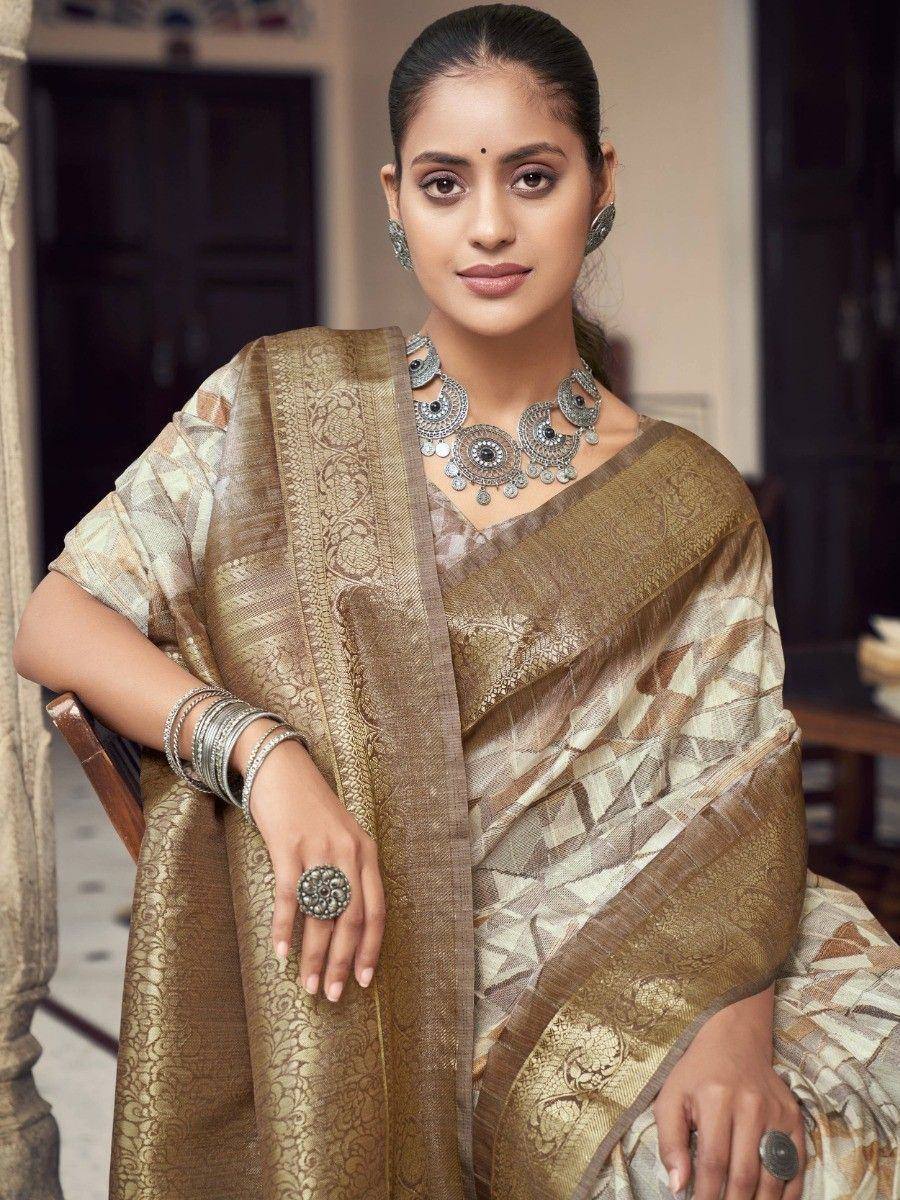 Elegant woman in designer saree with gold and beige pattern, traditional jewelry, perfect for ethnic occasions