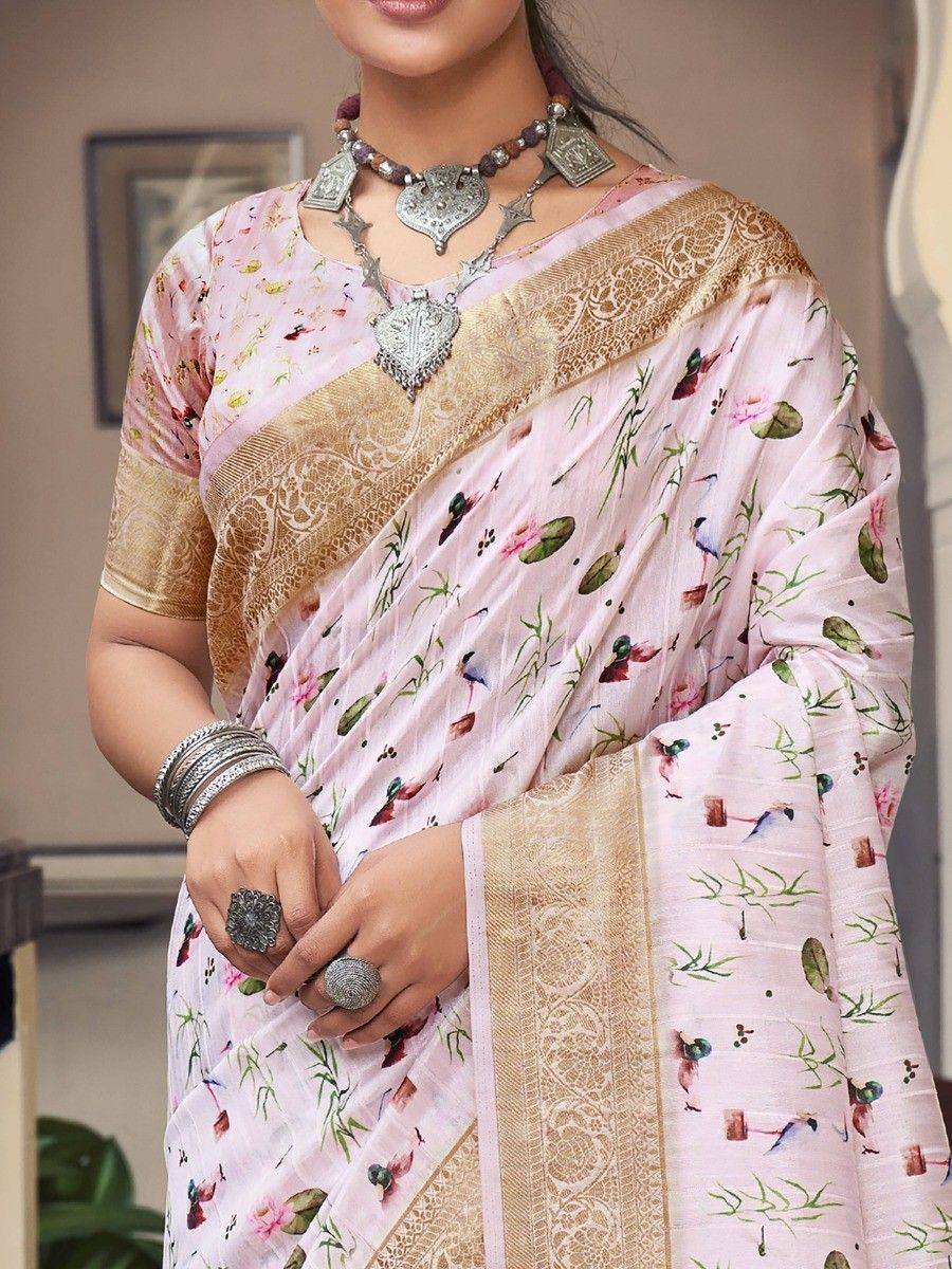 Pink floral print saree with gold border, paired with silver ethnic jewelry for traditional Indian wear