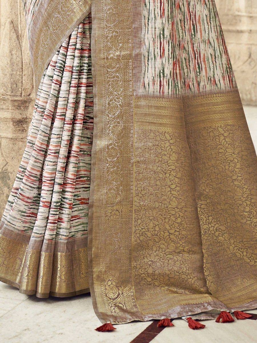 Elegant ethnic saree with gold brocade border and red tassels, perfect for Indian occasions