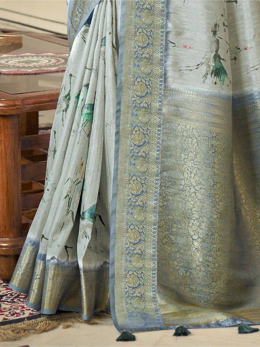 Elegant designer saree with floral print and intricate gold border, perfect for ethnic occasions