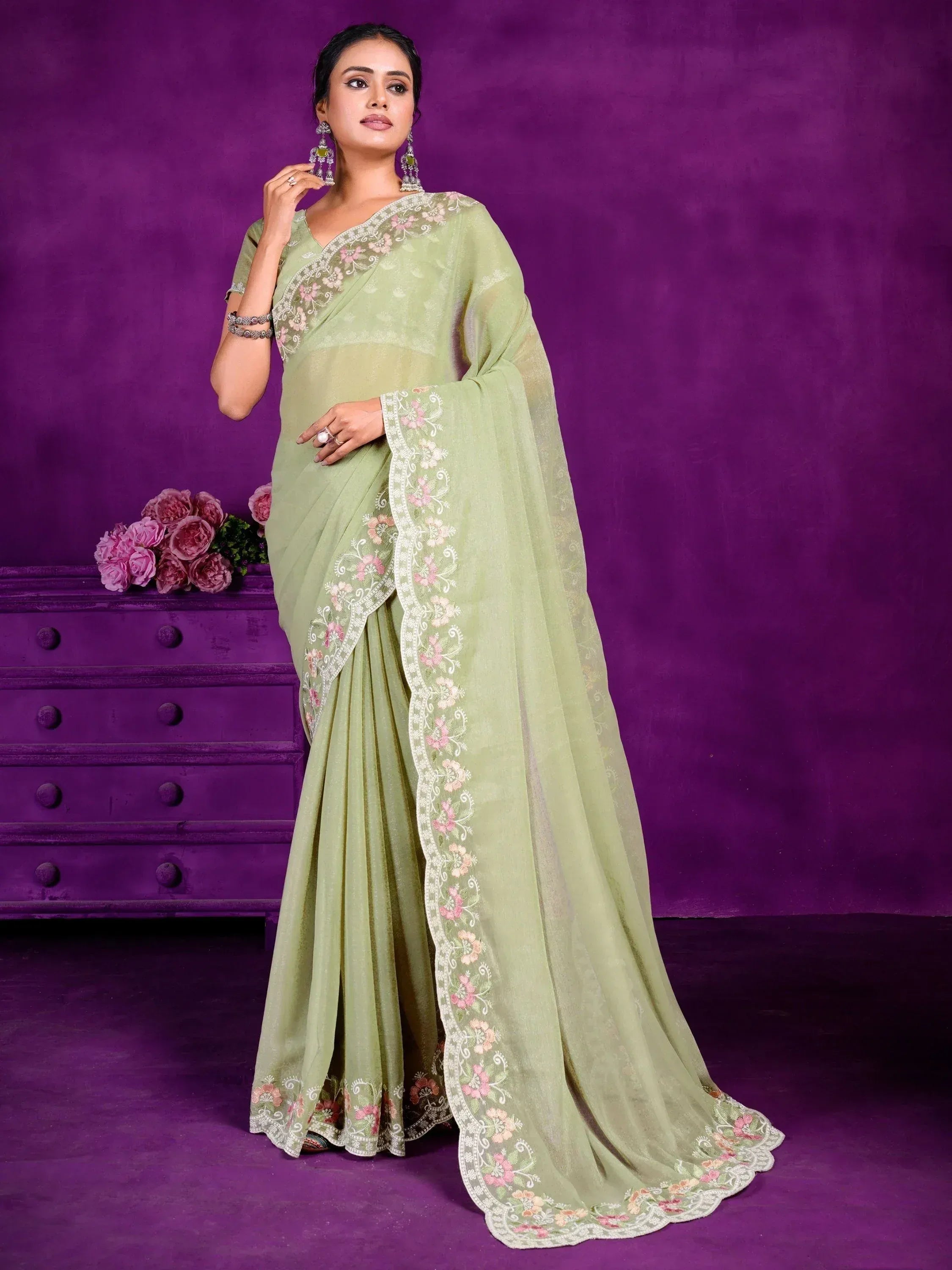 Light green embroidered saree with floral border, styled for Indian ethnic wear occasions