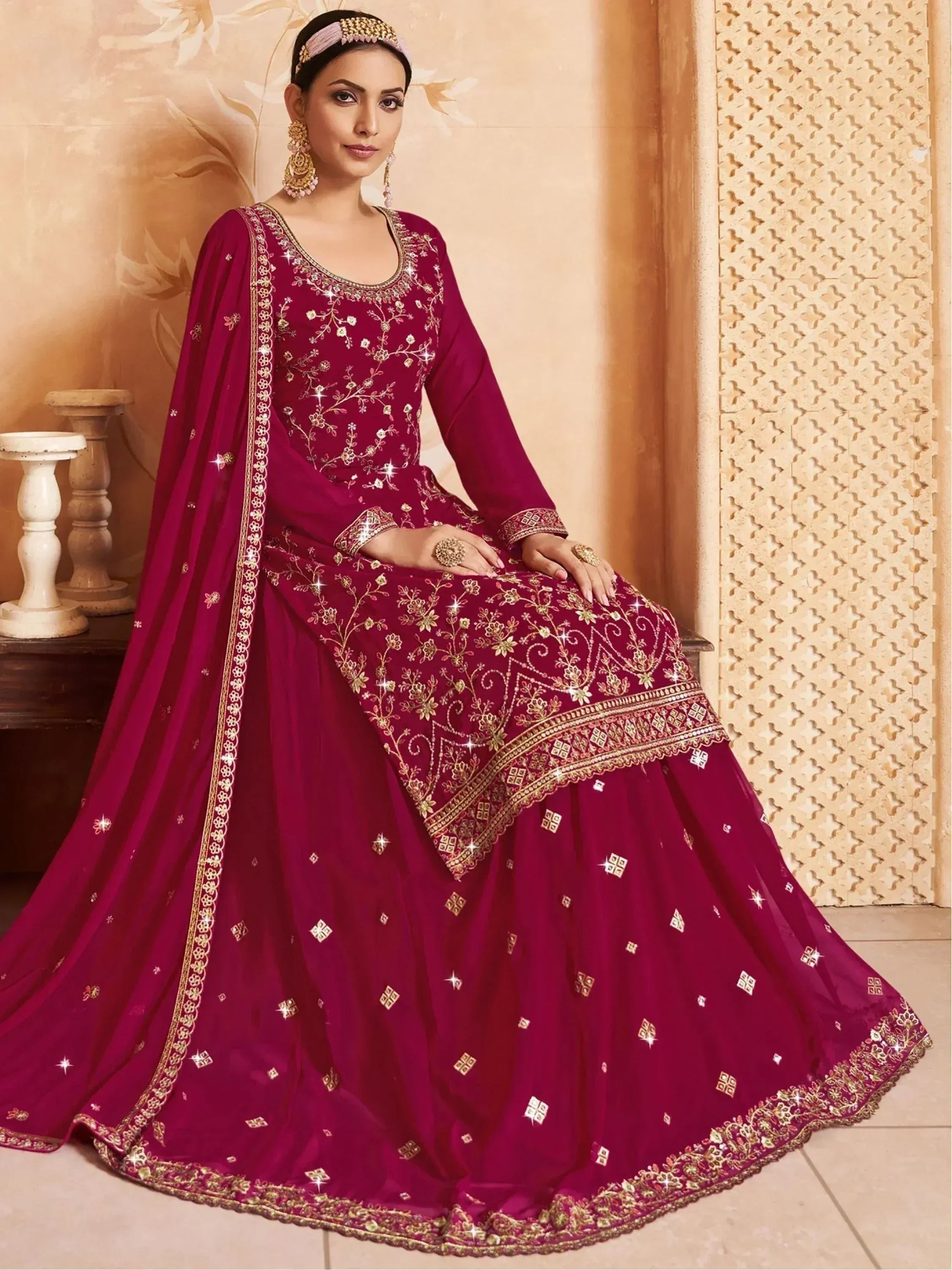 Elegant maroon Indian ethnic gown with gold embroidery and mirror work, perfect for weddings and festivals.