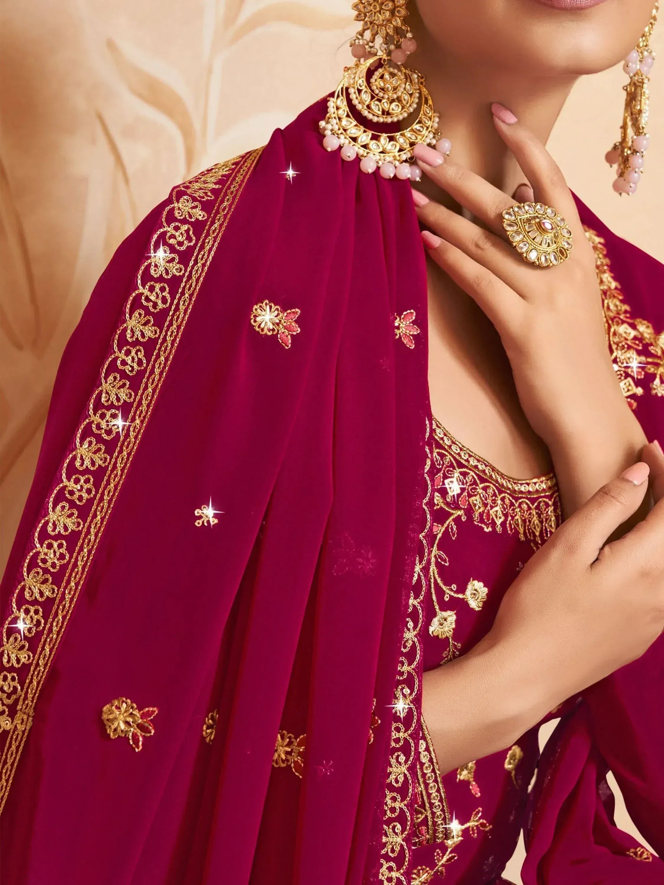Rich maroon ethnic gown with gold embroidery and matching jewelry for festive occasions