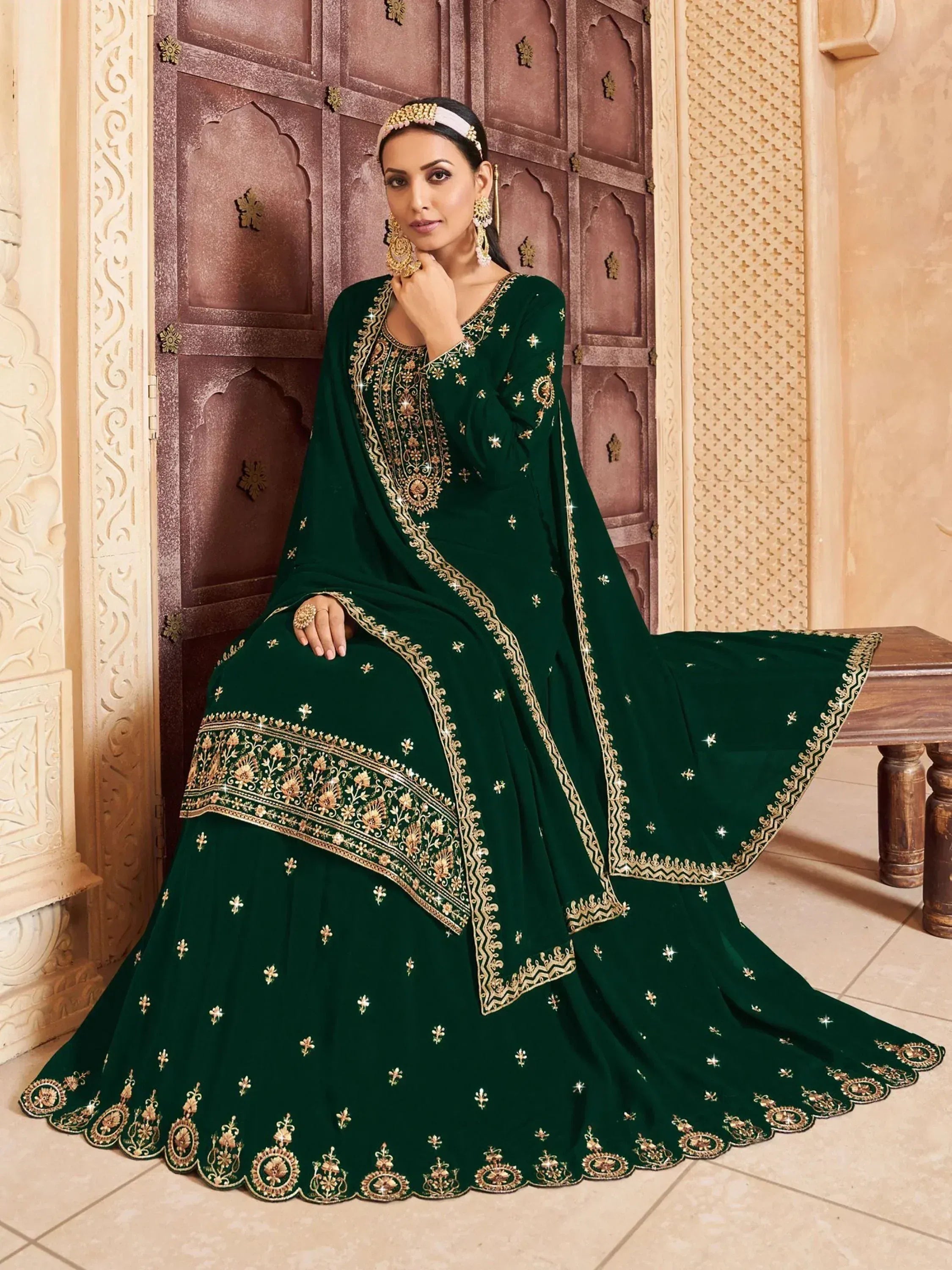 Emerald green embroidered ethnic gown with gold detailing, perfect for Indian weddings and festive occasions