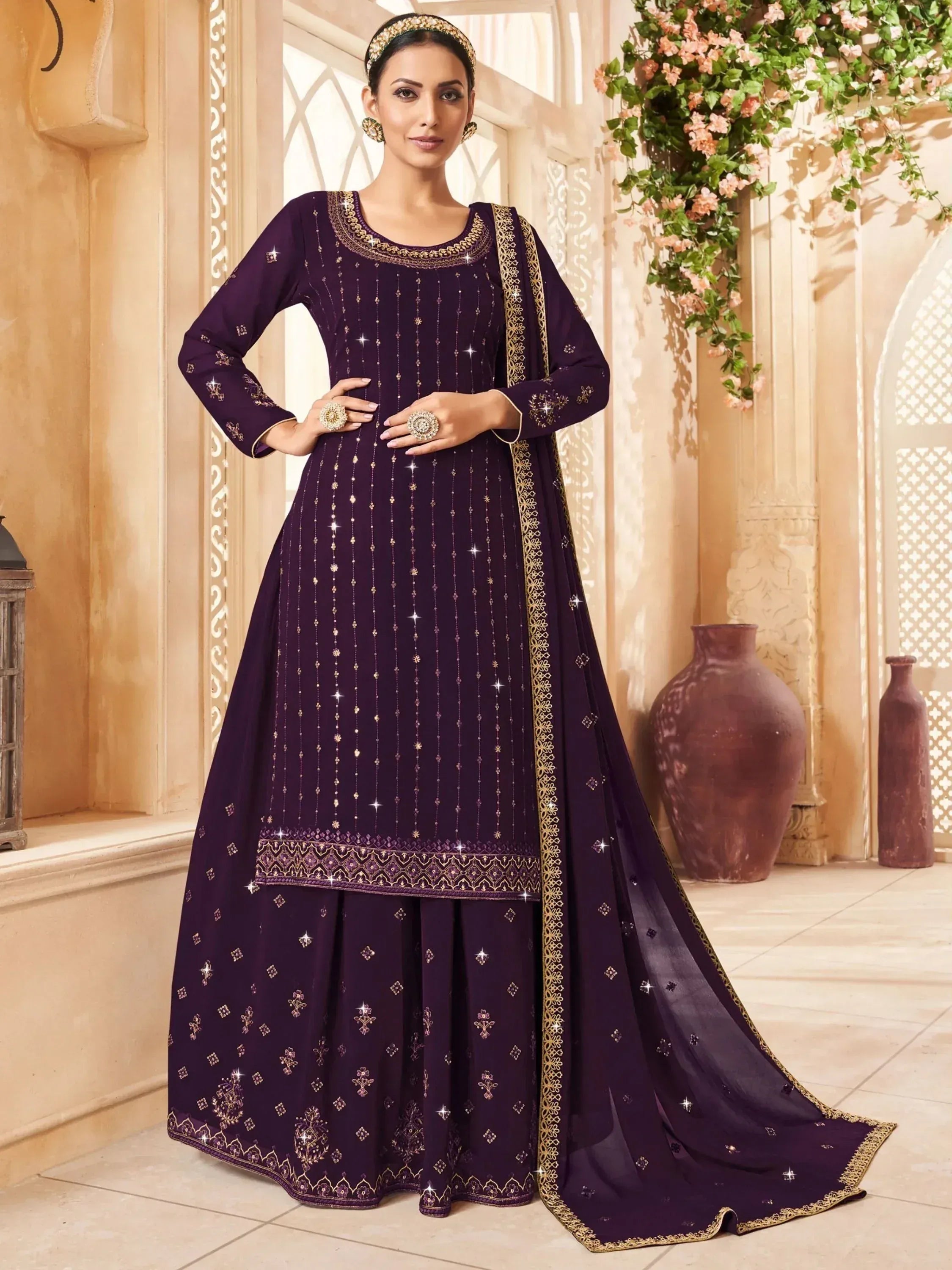 Elegant purple ethnic salwar kameez with gold embroidery and sequins, perfect for festive occasions.
