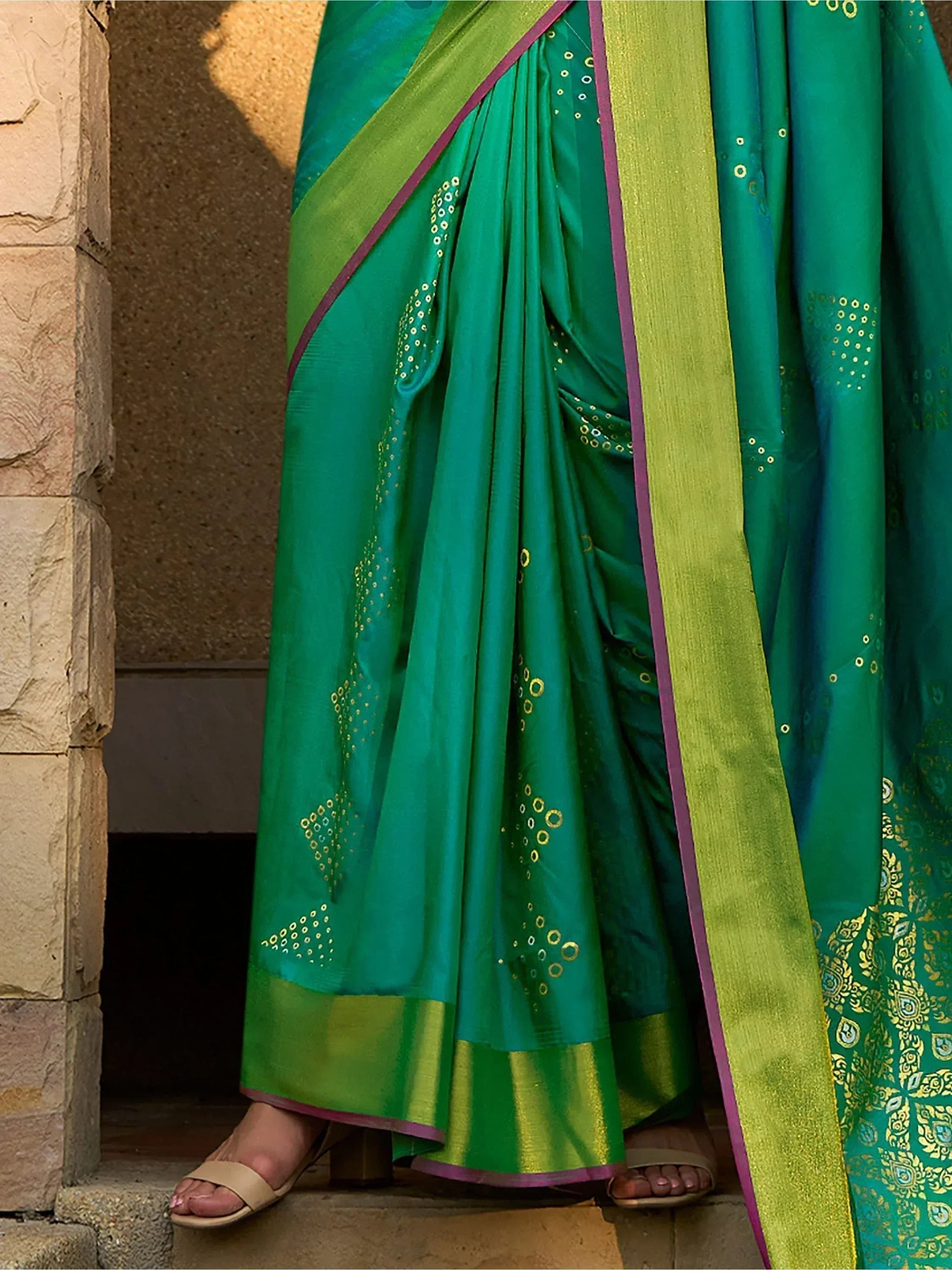 Emerald green saree with gold embroidery and lime border, styled for ethnic wear