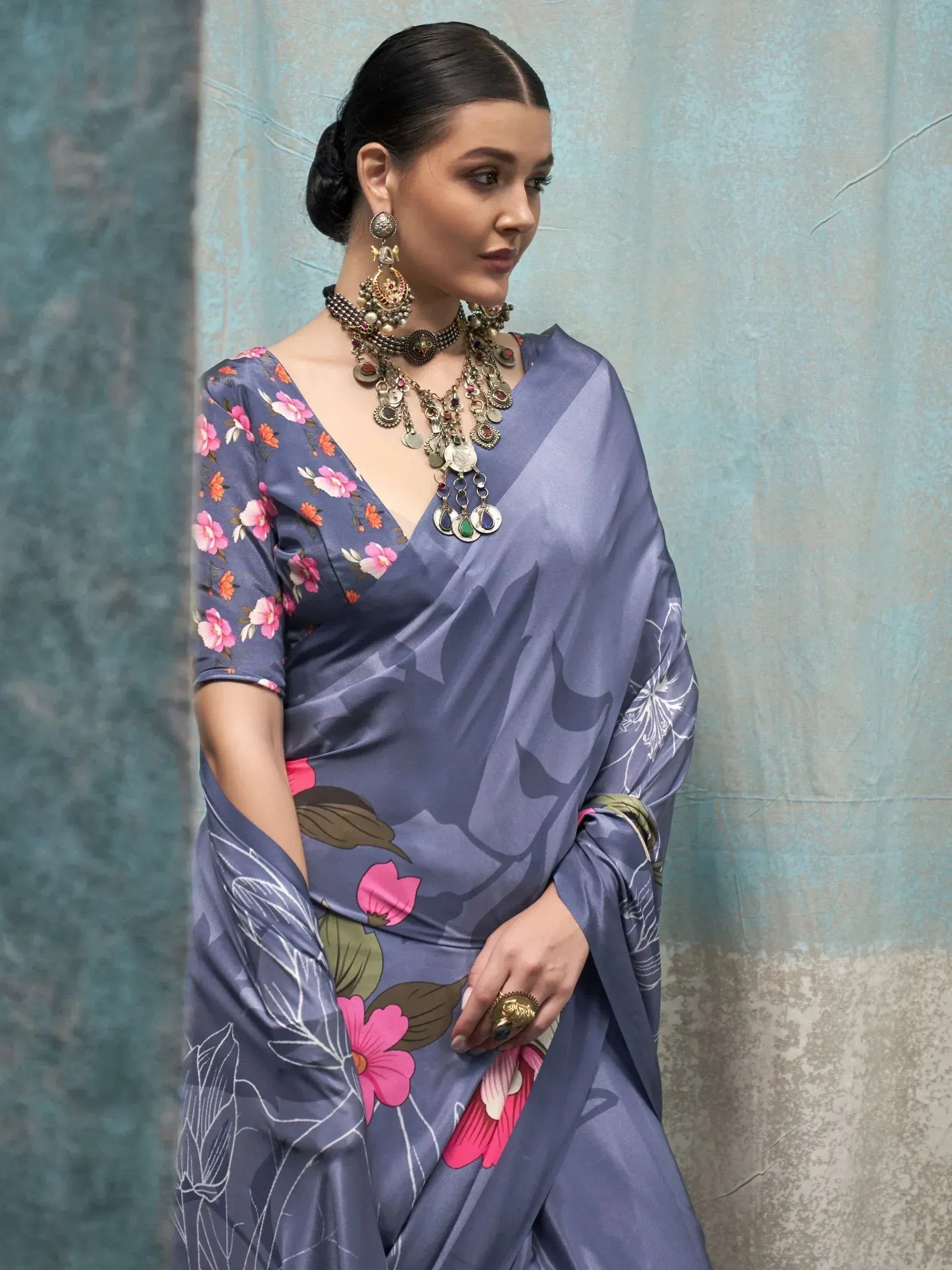 Woman in blue floral saree with designer blouse and ethnic jewelry, perfect for Indian occasions