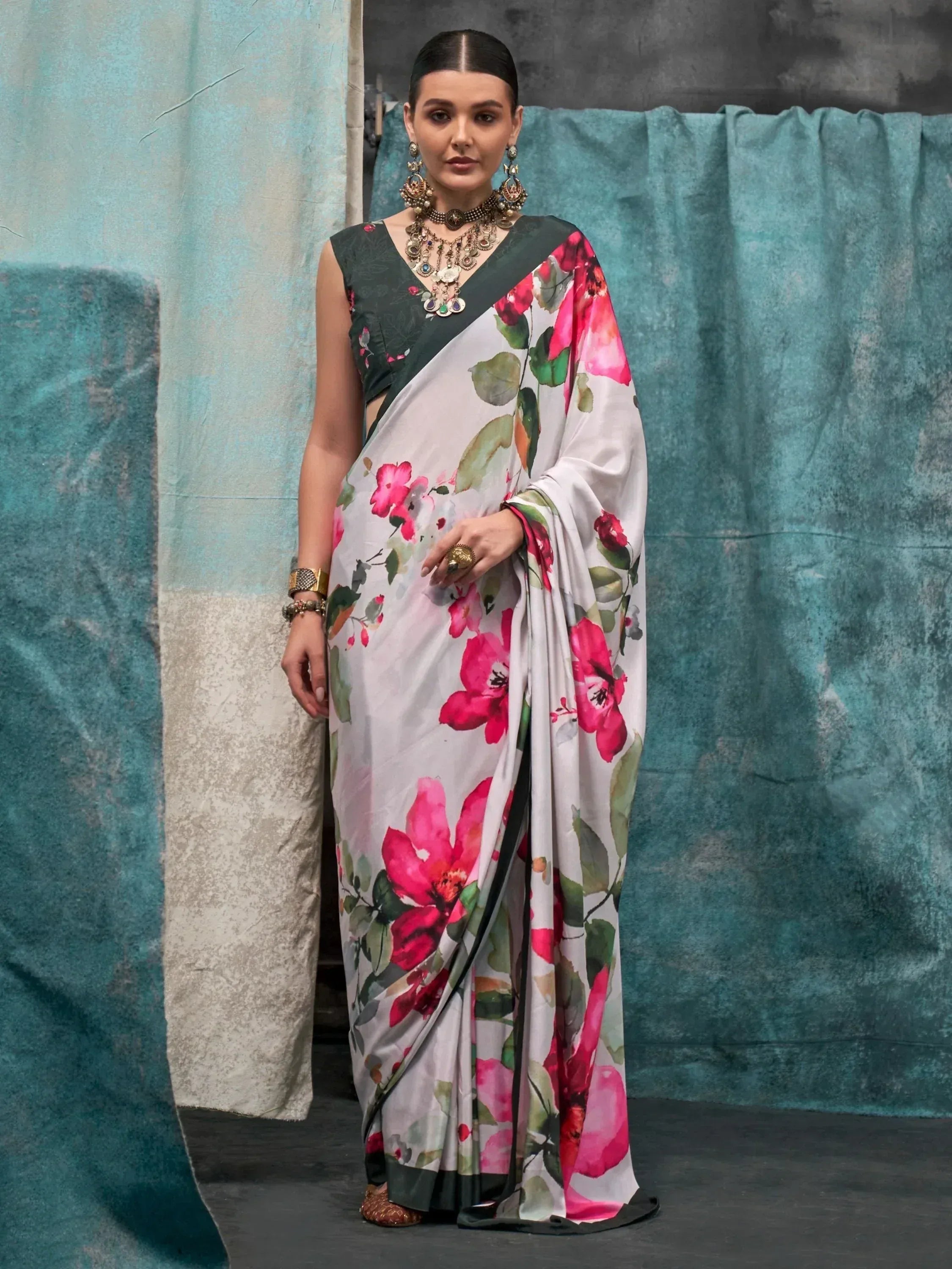 Floral print saree with green border, paired with ethnic jewelry for Indian ethnic wear