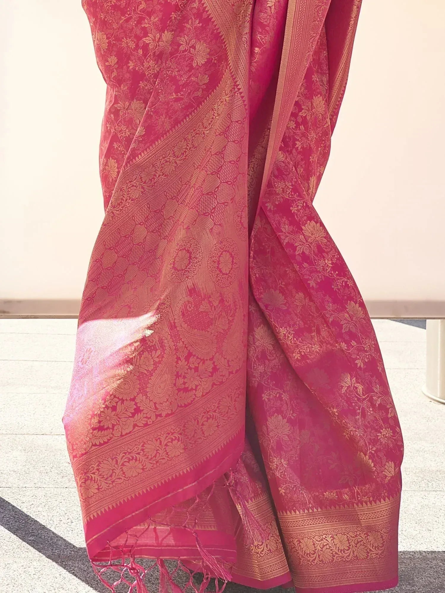Pink floral brocade saree with gold paisley border, ideal for Indian ethnic wear occasions
