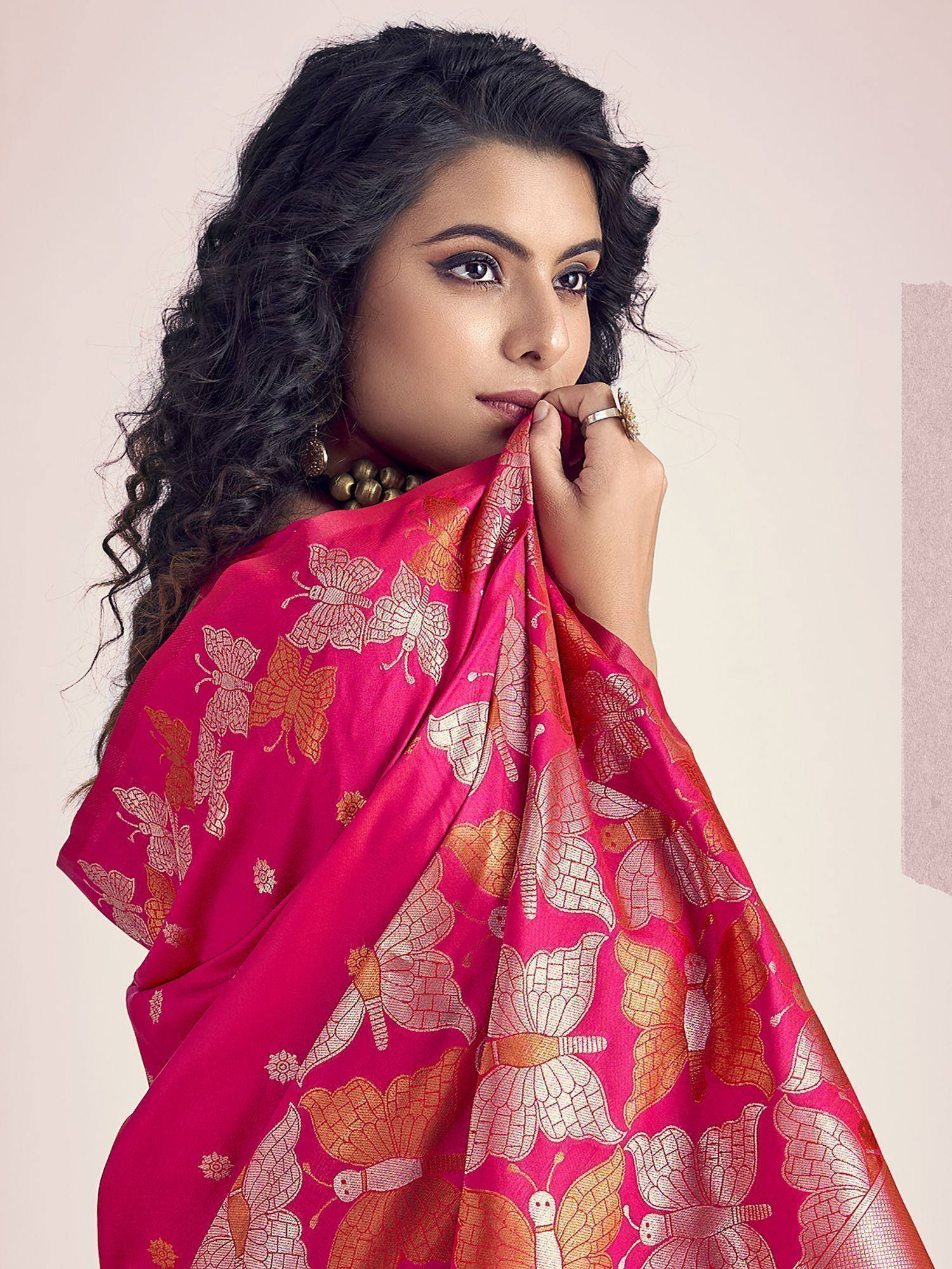 Woman in vibrant pink saree with golden butterfly print, ethnic Indian wear
