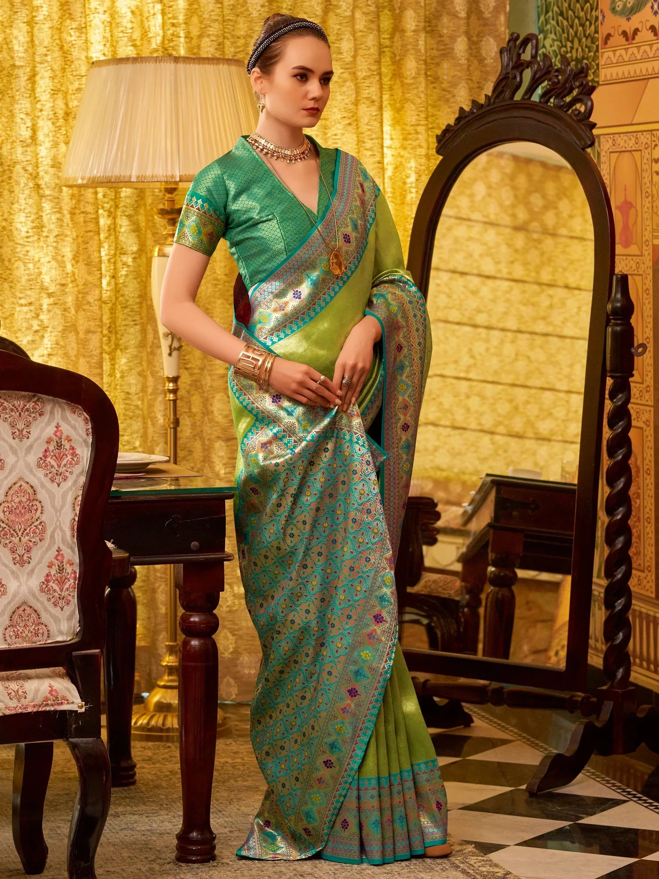 Elegant green and teal saree with intricate floral patterns, perfect for Indian ethnic wear occasions.